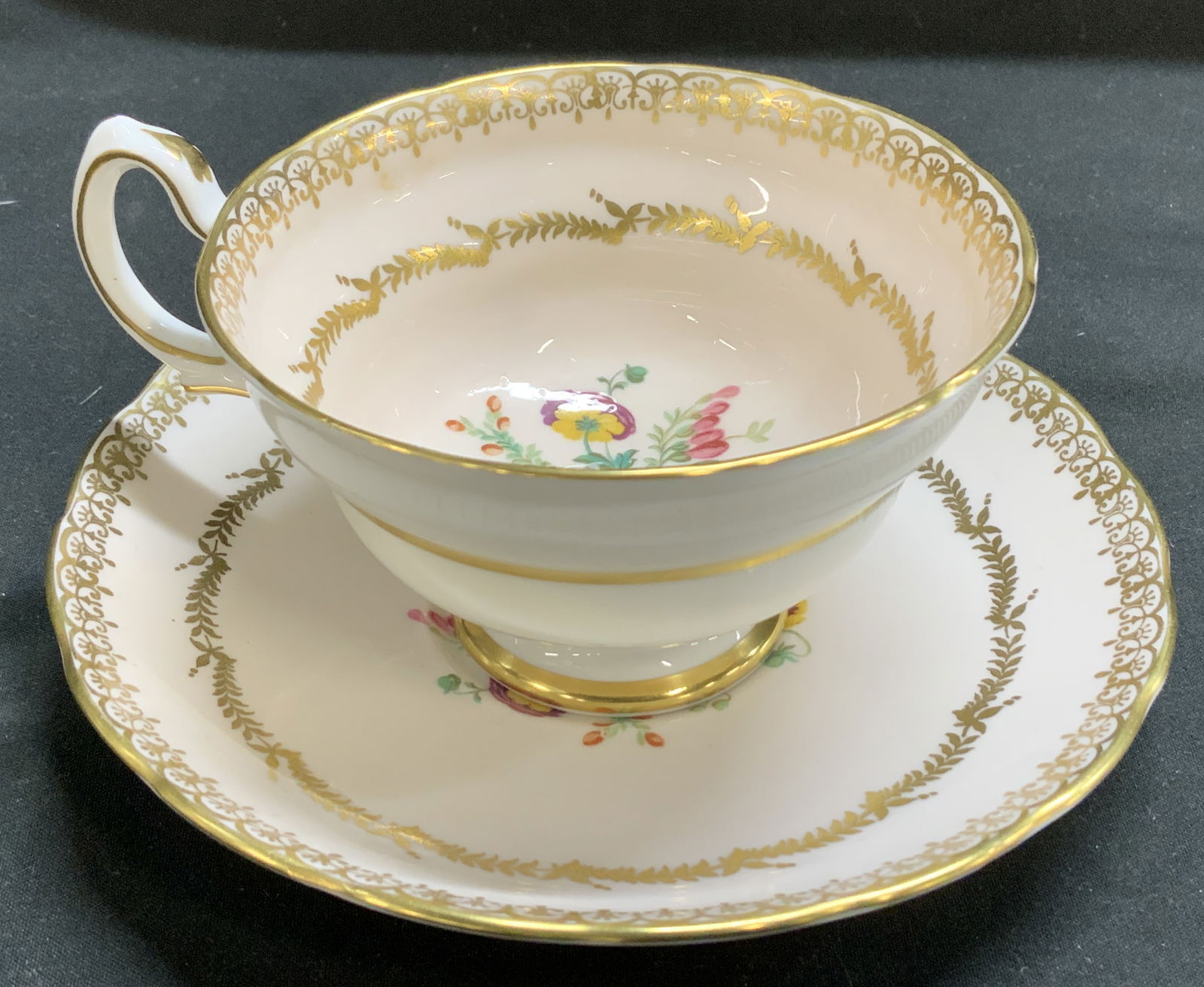 Vntg Grosvenor Bone China Teacup & Saucer ENGLAND: Features a floral design with a gold trim & laurel wreath pattern. Teacup & saucer are bone china material. Surface wear consistent to age, use & exposure. Signed & marked. Reads, GROSVENOR BONE CHINA