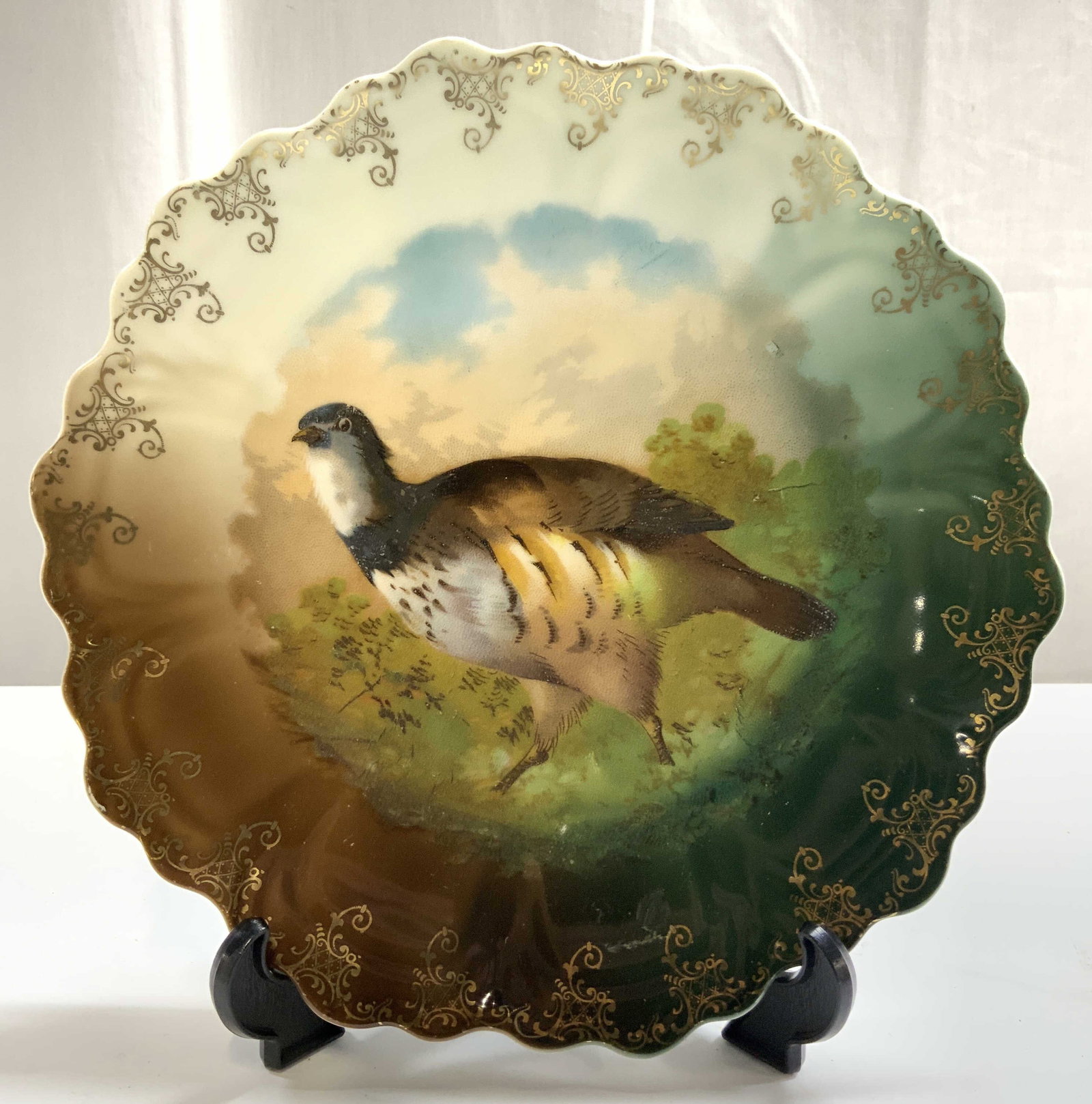 Z S & Co Zeh Scherzer Bavaria Game Bird Wall Plate: Underside is marked for PUNCH Z S & CO BAVARIA. Wall plate is vintage and porcelain. Piece has depiction of game bird, possibly & Quail or partridge. Piece has gilt scroll detail near rim. Plate rim h