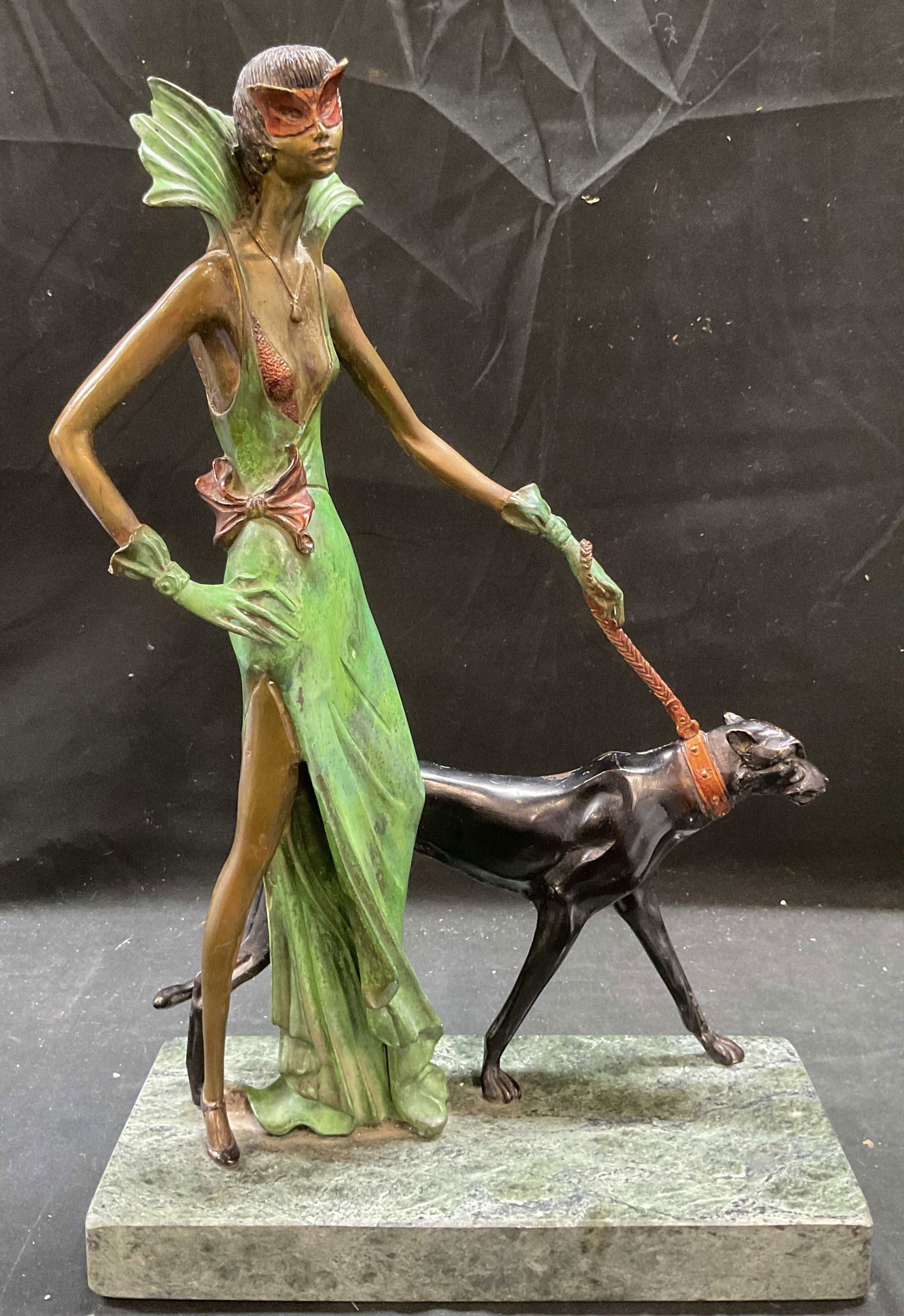 After CHIPARUS Mascarade Bronze Sculpture: Cast bronze sculpture on green marble base. After DEMETRE CHIPARUS (Romanian/French, 1886-1947). Mascarade. Art Deco styled woman walking dog. Impressed mark CHIPARUS near base. Piece is heavy. Measur