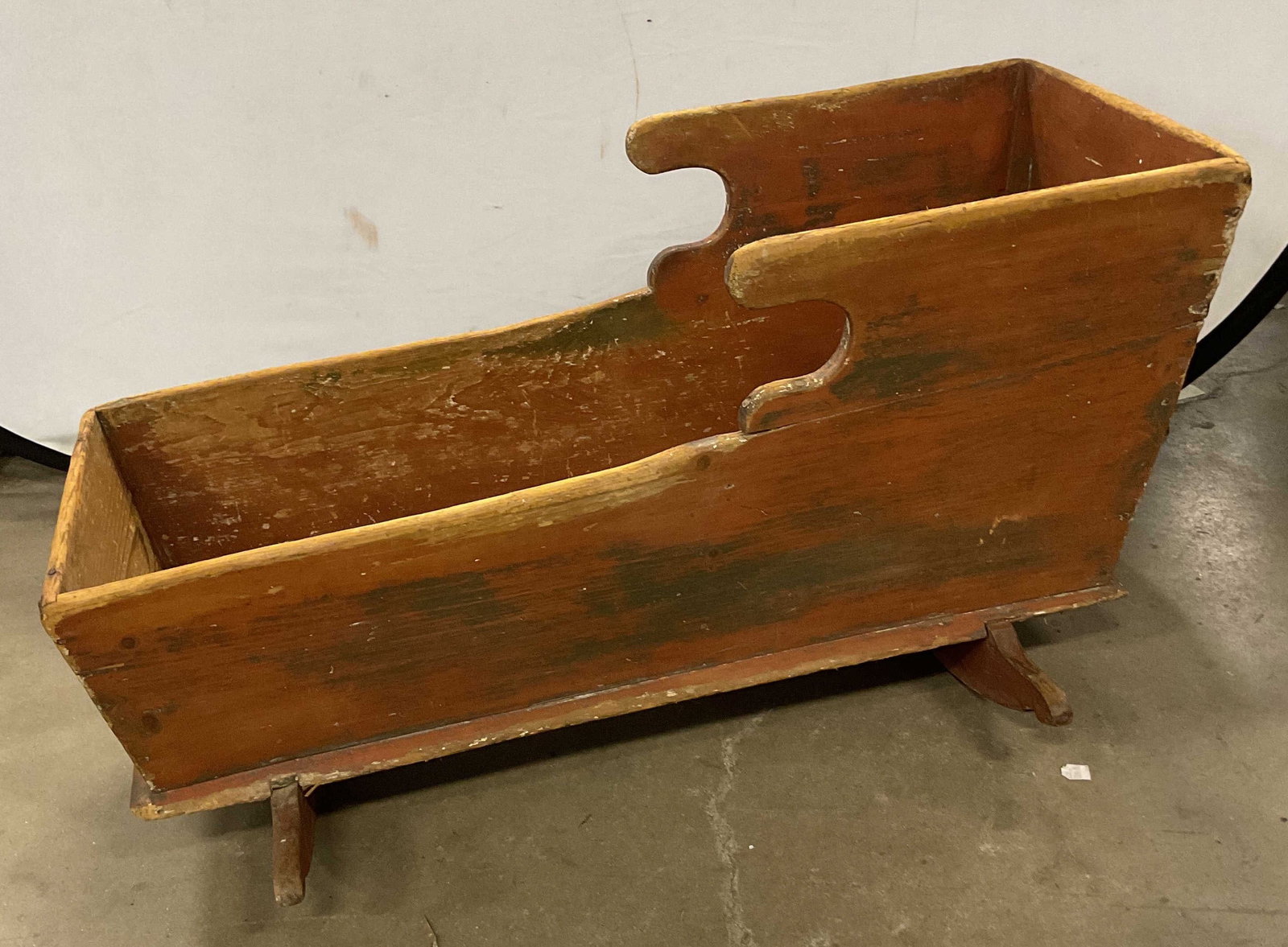 Antique Handcrafted Wooden Rocking Cradle 37in: Antique wooden cradle. Rocking feet on base. Handcrafted with painted finish. Measures approx 37 x 18 x 20.5 inches. Surface wear consistent with age and exposure. Loss to paint, scratches, and chips.