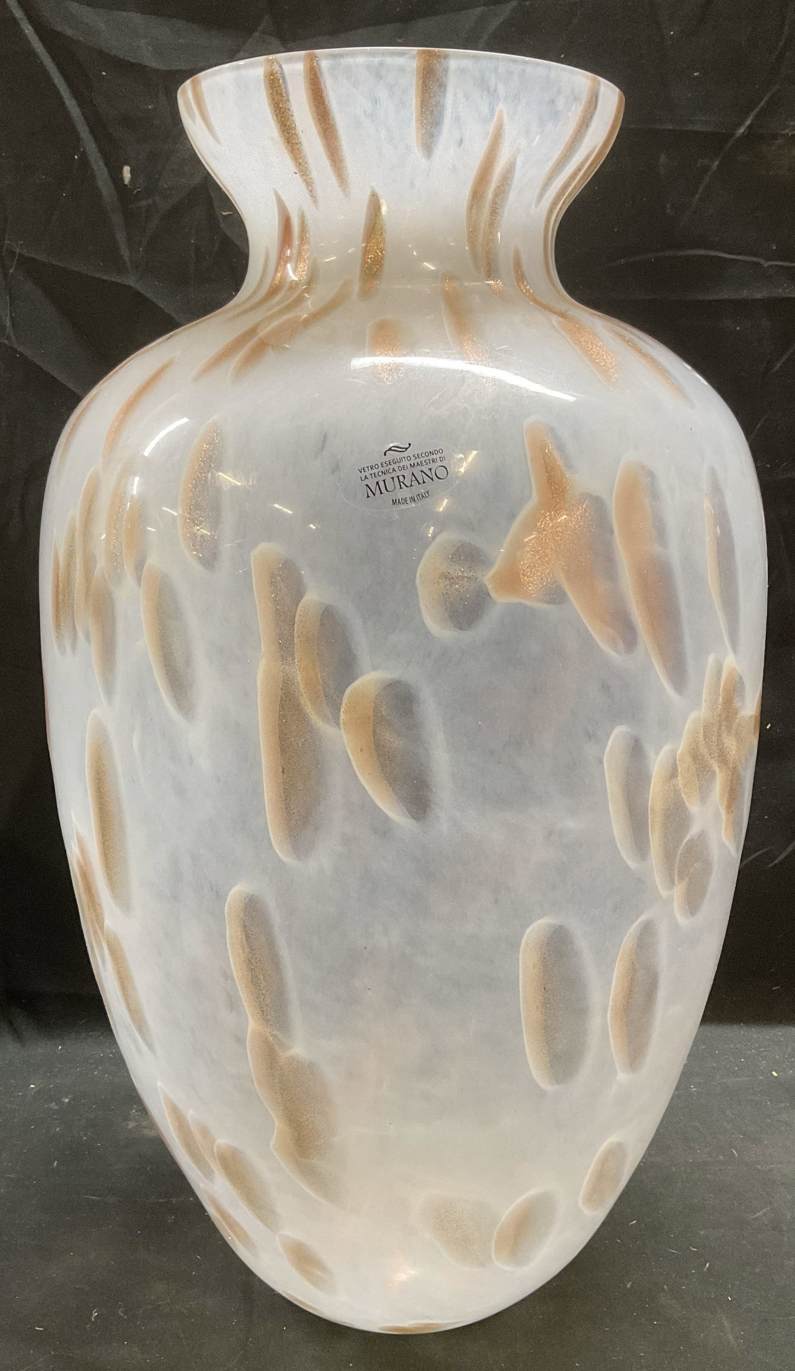 MURANO White & Gold Art Glass Vase, Italy 20 In: MURANO hand blown art glass vase. White and gold fleck dot pattern. Elongated tapered shape with fluted rim. Signed on label. Made in Italy. Measures approx 11 x 20 inches. Some scratches on base. MUR