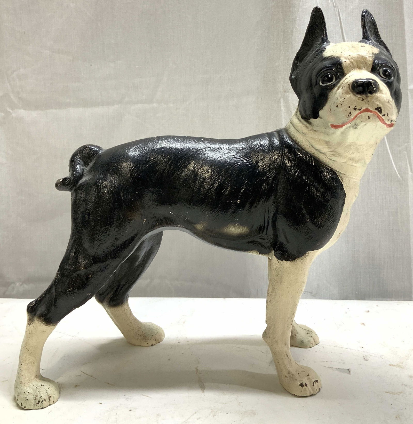 Vntg Cast Iron Boston Terrier Doorstop: Vntg Cast Iron Boston Terrier Doorstop Doorstop is cast iron material & is depicting a Boston terrier dog. Dog is in a standing position. Surface wear consistent to age, use & exposure. Measurements: