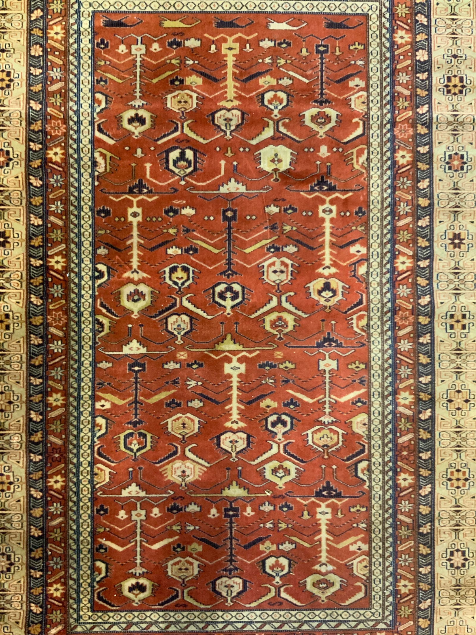 SERAFIAN PATINE H Made Persian Fringed Wool Rug: Tag on underside reads ADOROS SERAFIAN PATINE. Rug appears to be handmade and wool. Persian rug with intricate multi toned geometric & floral motif detail. Edges of rug have cream toned fringes. Rug i