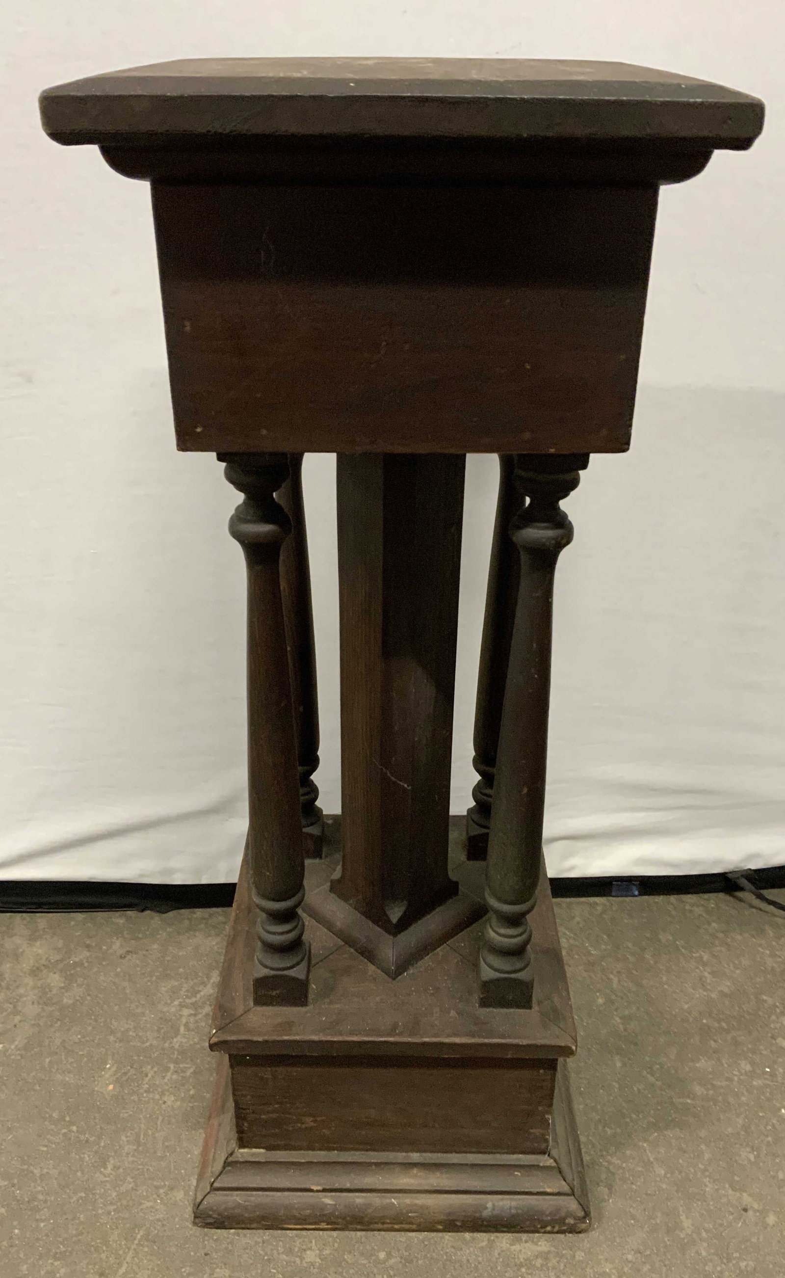 Antique Wooden Pedestal circa Late 1880s: Pedestal is antique, appears to be late 1880s. Piece is brown toned and wooden. Pedestal has 4 column style supports. Piece has square form top surface, Measures approx 36 inches tall 14 inches square