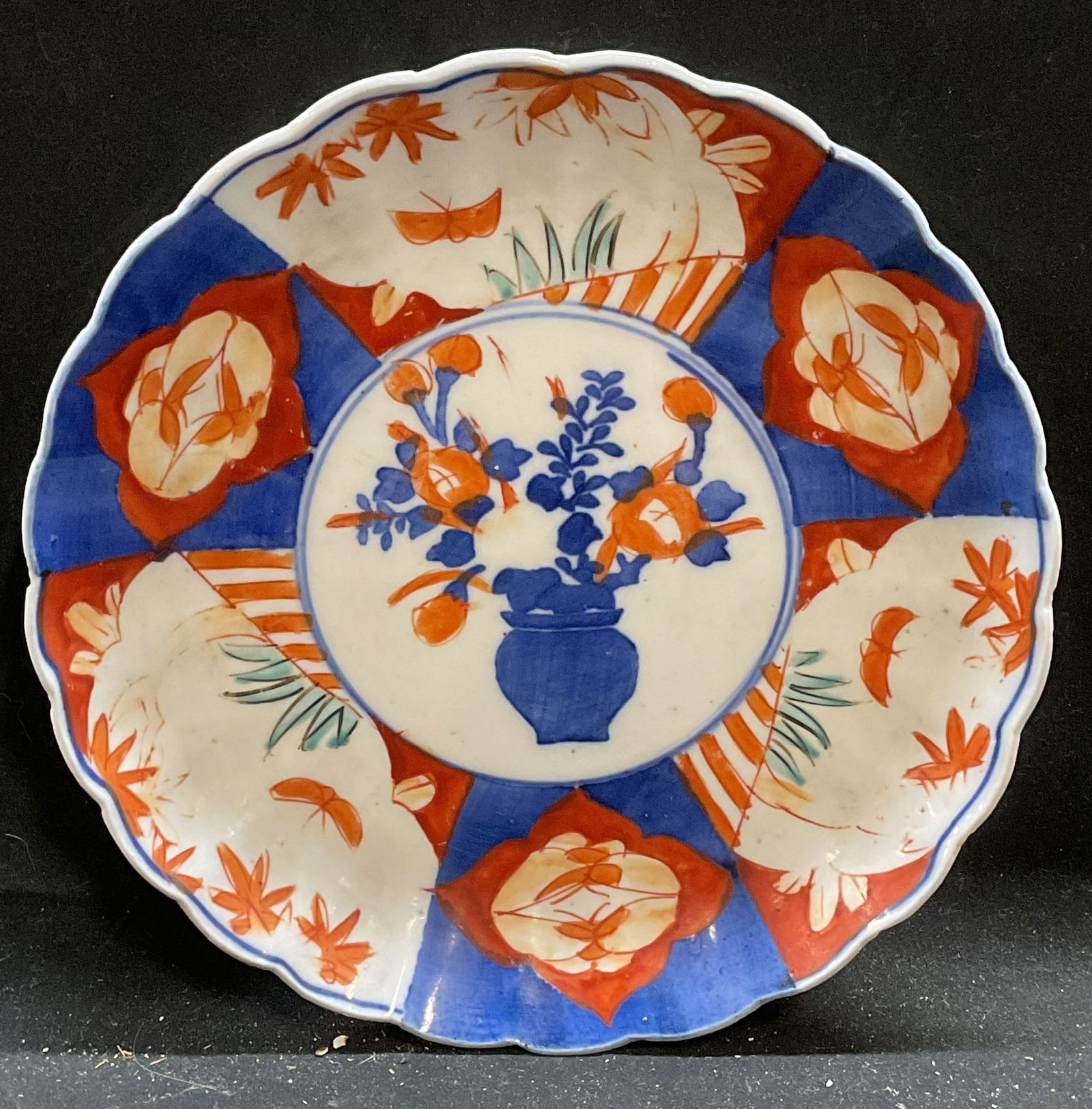 Antique Asian Imari Porcelain Floral Plate: Antique Asian Imari porcelain plate. Hand painted in red and blue with floral and traditional Asian motifs. Scalloped rim. Measures approx 8 x 1.5 inches. Some loss to paint and scratches. Antiques, a