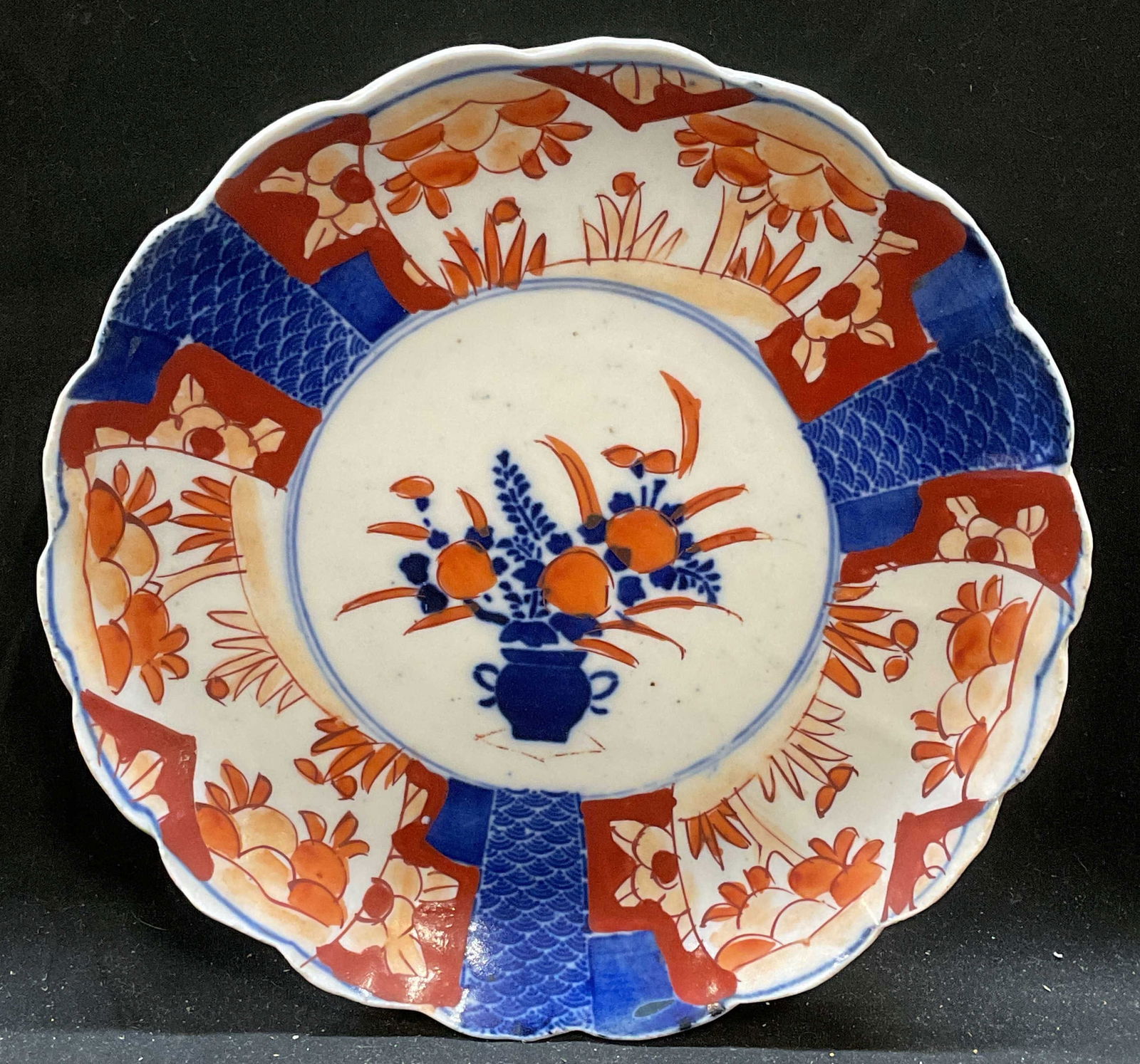 Antique Asian Imari Porcelain Plate: Antique Asian Imari porcelain plate. Hand painted in red and blue with floral and traditional Asian motifs. Scalloped rim. Measures approx 8 x 1.5 inches. Some loss to paint and scratches. Antiques, a