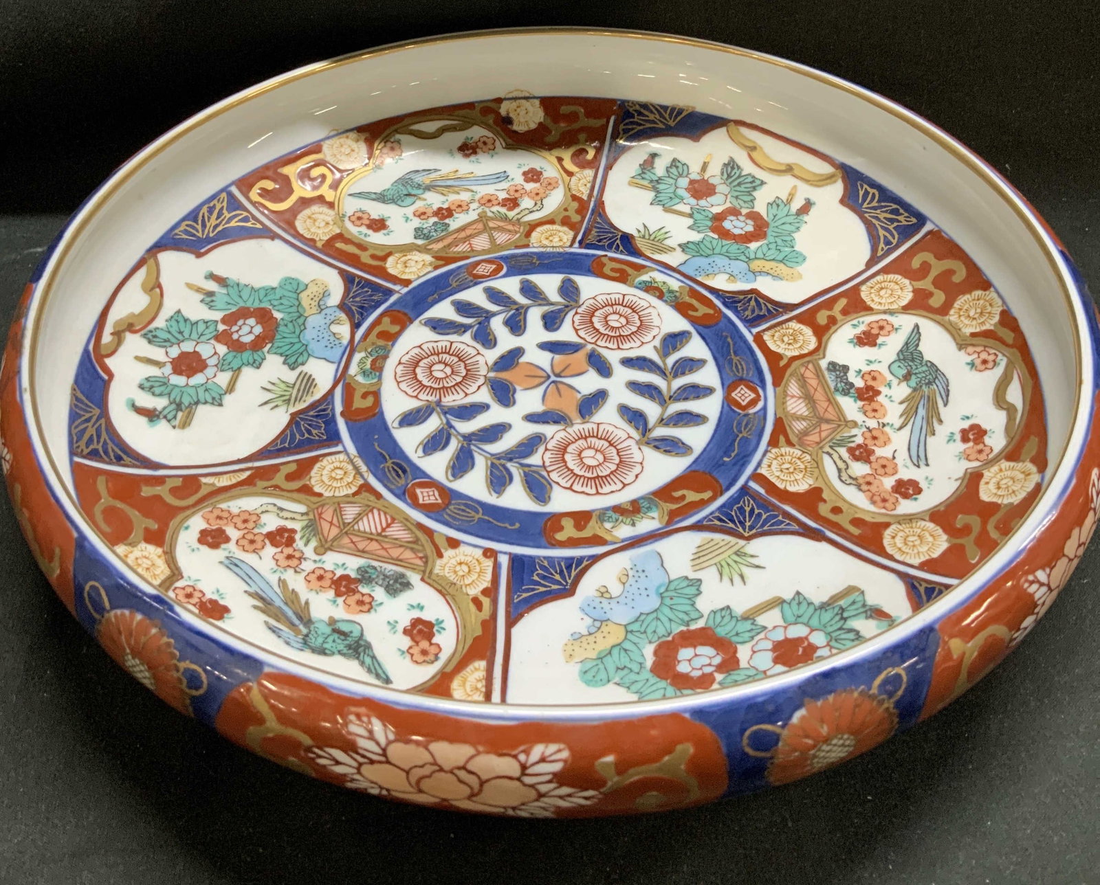 Gold Imari Hand Painted Shallow Bowl Toyo JAPAN: Gold Imari Hand Painted Shallow Bowl Toyo JAPAN The bowl is adorned with detailed patterns, including floral motifs, birds, and geometric designs, arranged in distinct sections within the bowls interi
