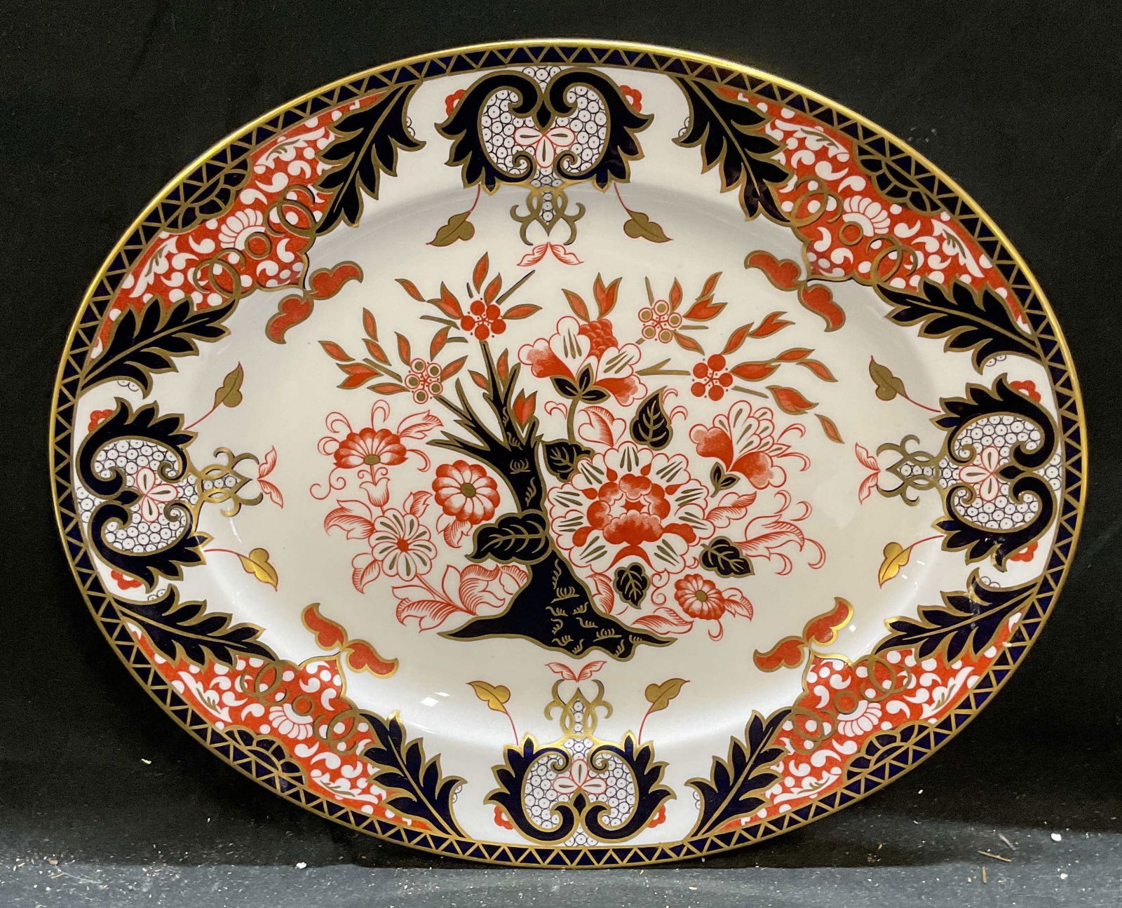 Royal Crown Derby Kings Imari China Platter: Royal Crown Derby fine bone china oval serving platter. Kings Imari pattern. Botanical motif in palette of blue and red with gilt decoration. Hand painted details. Signed with backstamp. Measure appro