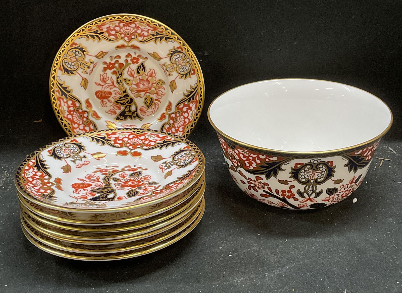 9 Royal Crown Derby Kings Imari Saucers & Bowl: Set of 9 Royal Crown Derby fine bone china tableware pieces. 8 saucers and 1 bowl. Kings Imari patterns. Palette of red and blue with gilt decoration. Hand painted details. Signed. Made in England. Sa