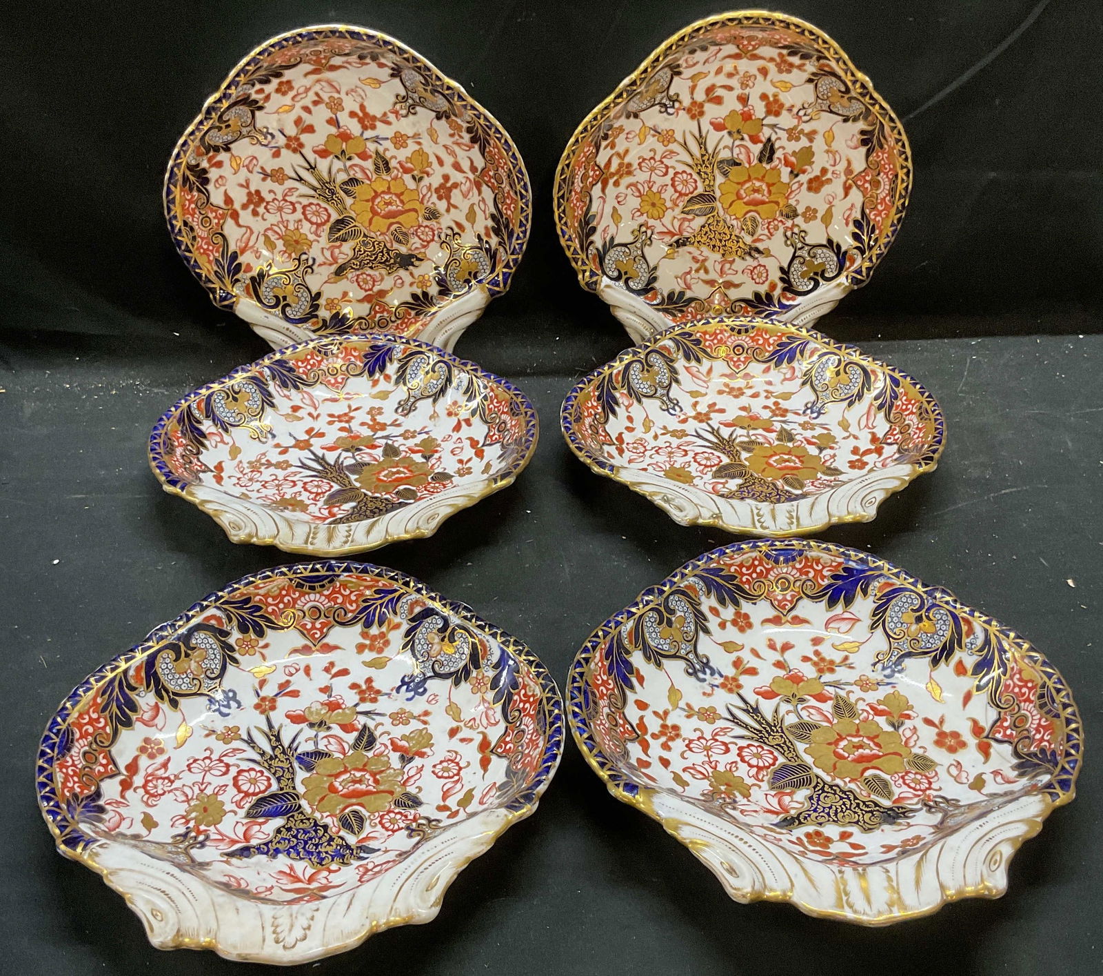 6 Antq Royal Crown Derby Kings Imari Dishes: Set of 6 antique Royal Crown Derby fine bone china serving dishes. Kings Imari patterns. Palette of blue and red with gilt decoration. Hand painted details. Shell shaped dishes with scalloped rim. Sig