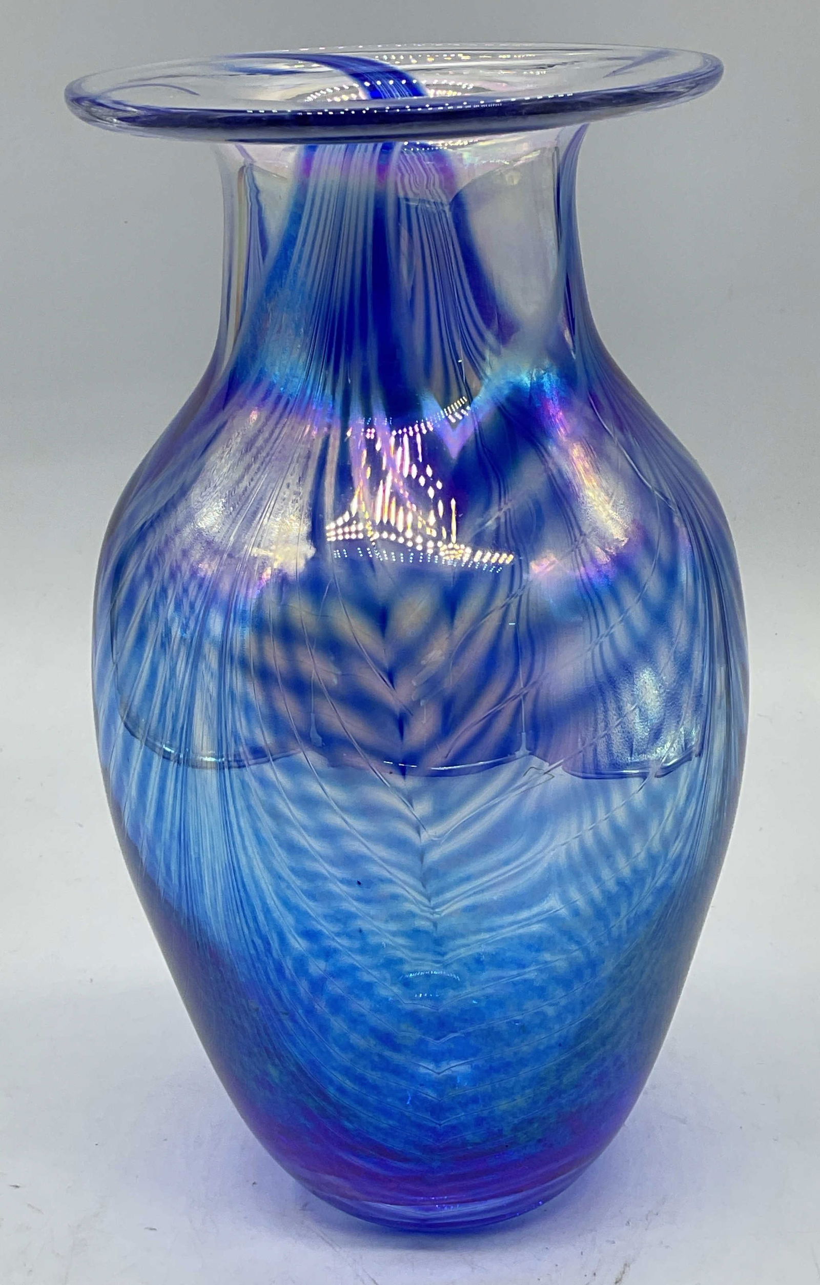 1993 Larson Blue Iridescent Art Glass Vase: Vintage hand blown art glass vase. Signed and dated Larson 1993. Blue with iridescent feather pull design. Tapered curved shale with fluted rim. Measures approx 4.5 x 8.5 inches. Minimal surface wear,