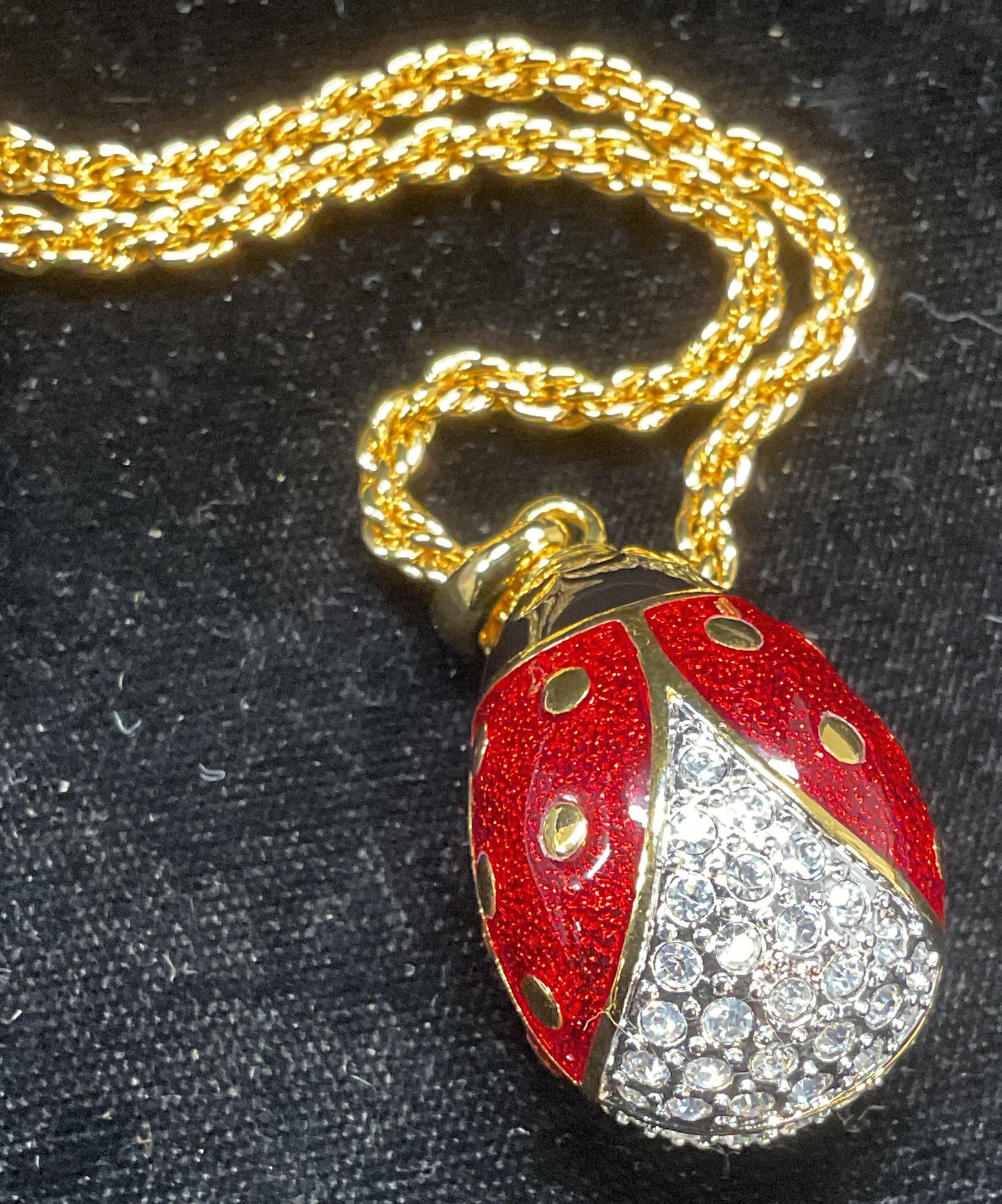 Joan Rivers Gold Tn Ladybug Pendant Necklace: Joan Rivers gold tone necklace with ladybug motif Pendant. Gold tone red and black enameled pendant with colorless crystals. Signed on hang tag. Includes original box. Drop length approx 14.5 inches. 