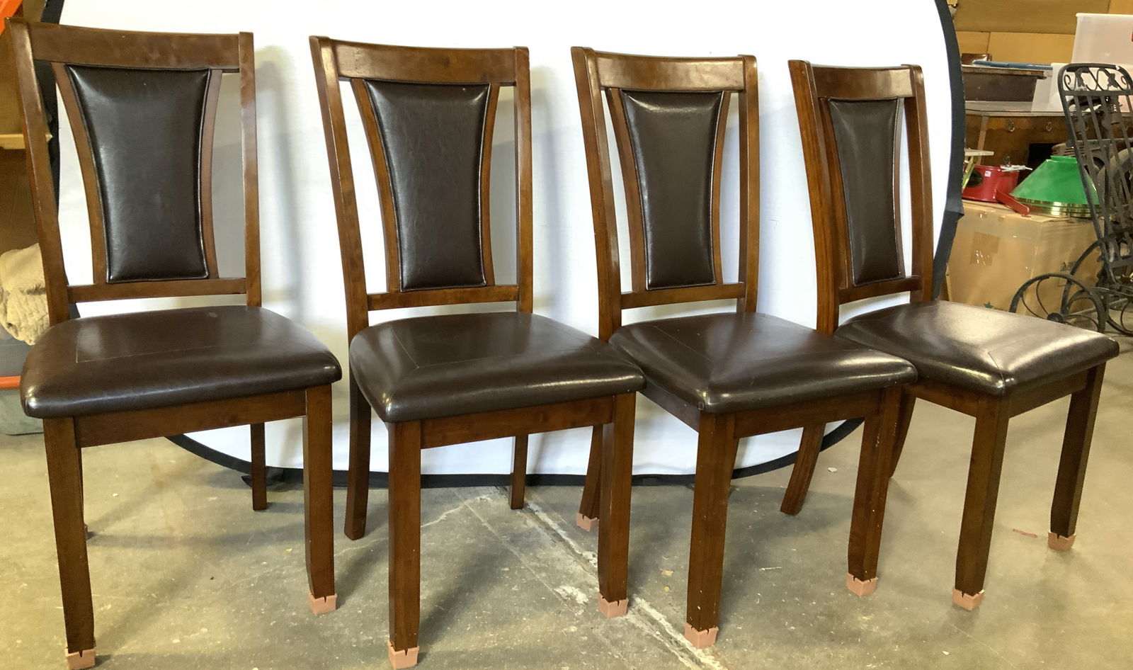 BIG LOTS INC Set 4 Wood Leather Uph Dining Chairs: Tags on undersides reads BIG LOTS INC. Lot includes 4 dining chairs. Each have brown toned wooden frames and brown toned leather upholstered seats. Measures approximately 38 inches tall 18 inches wide