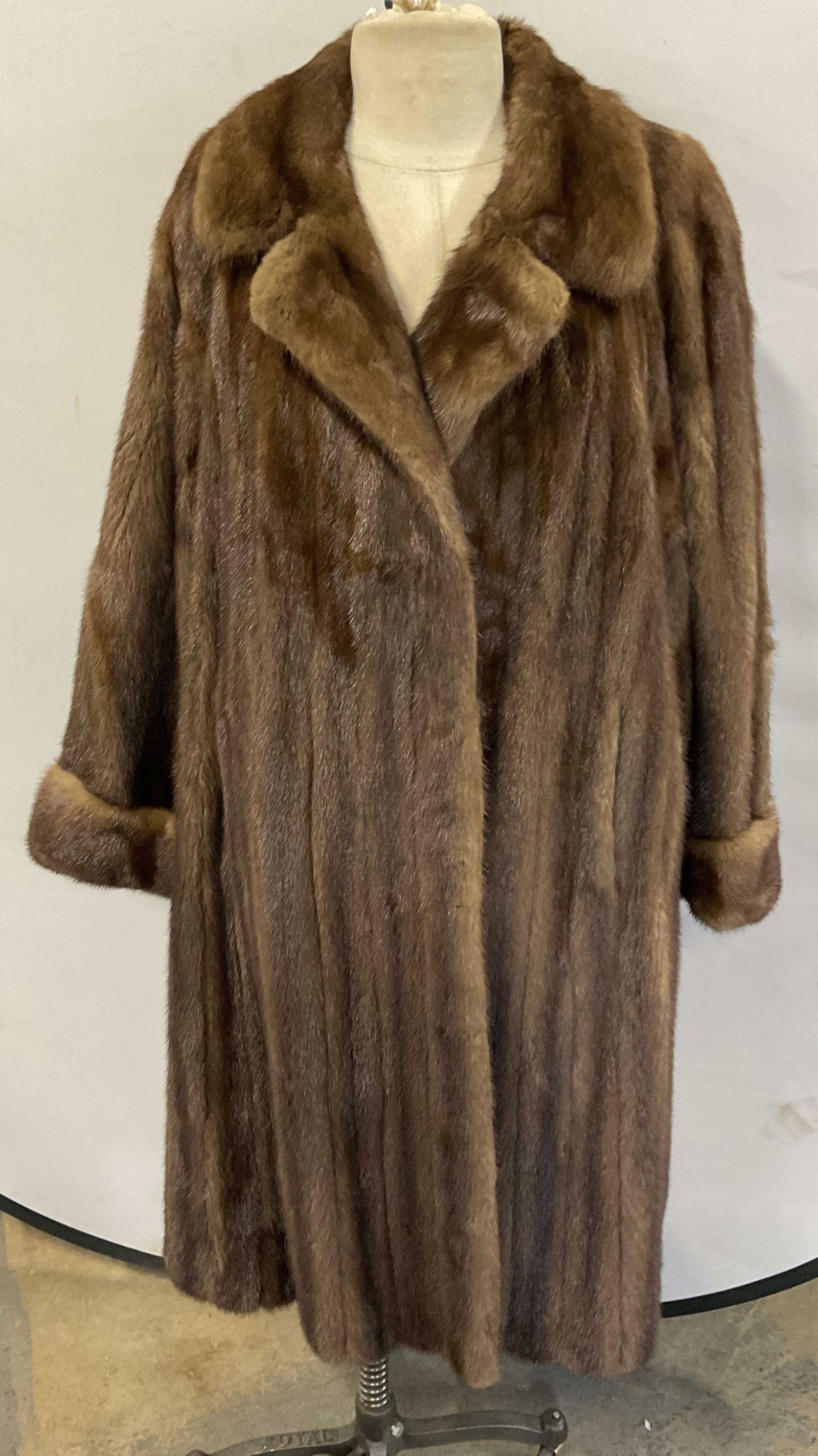 Vintage Brown Mink Fur Coat: Vintage brown mink fur coat. Notch collar and cuffed sleeves. Fully satin lined. Fur clip closure. Measures approx 21 inches across chest, 41 inches shoulder to hem. Small tear on outer shoulder. Fur