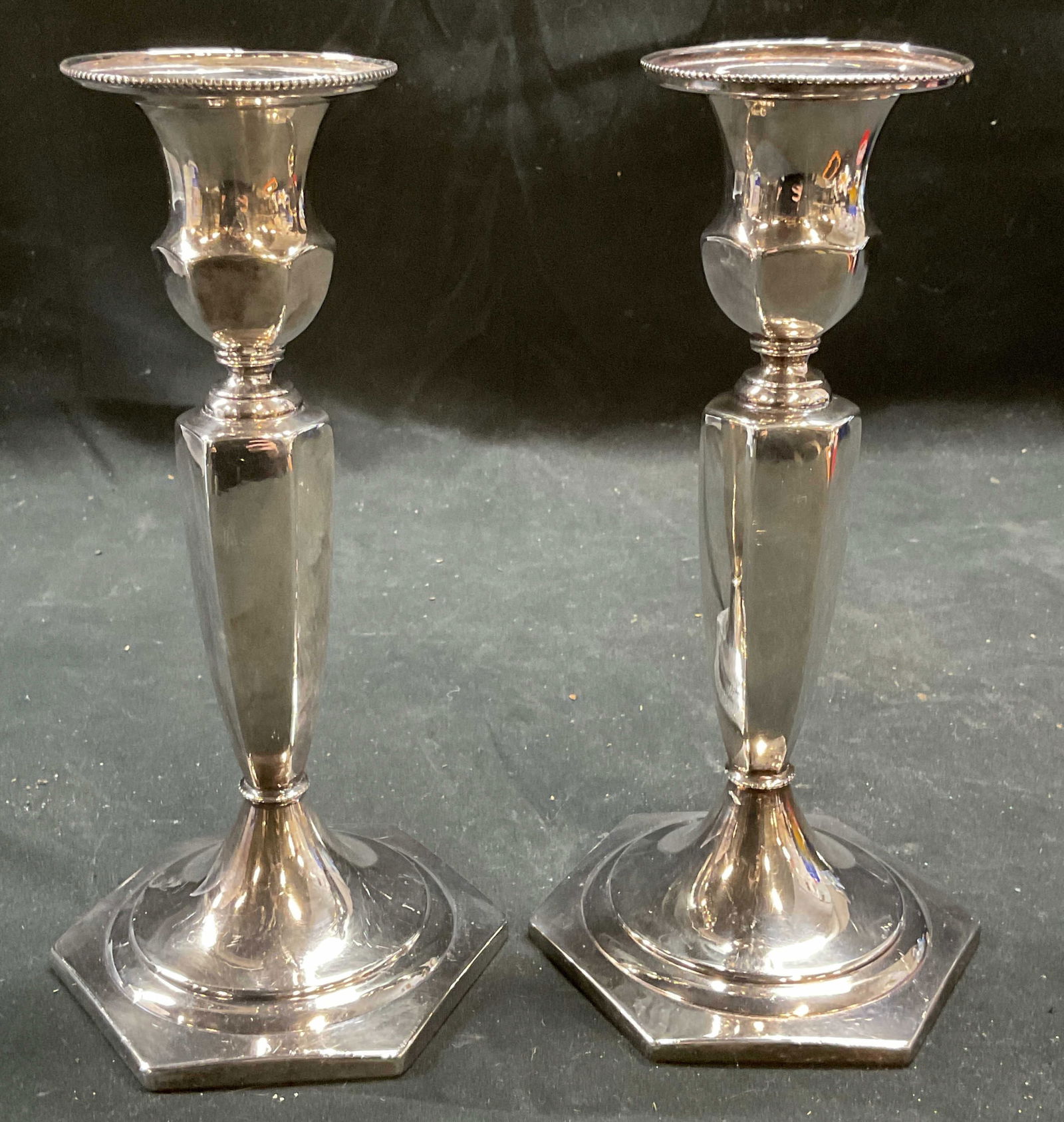 Pair Antq Superior Silver Co Plated Candlesticks: Pair of antique, possibly vintage, Superior Silver Co quadruple silver plated hollowware candlesticks. Backstamp on undersides. Pattern number 1208. Hexagon shaped base, tapered stem, fluted rims. Mea