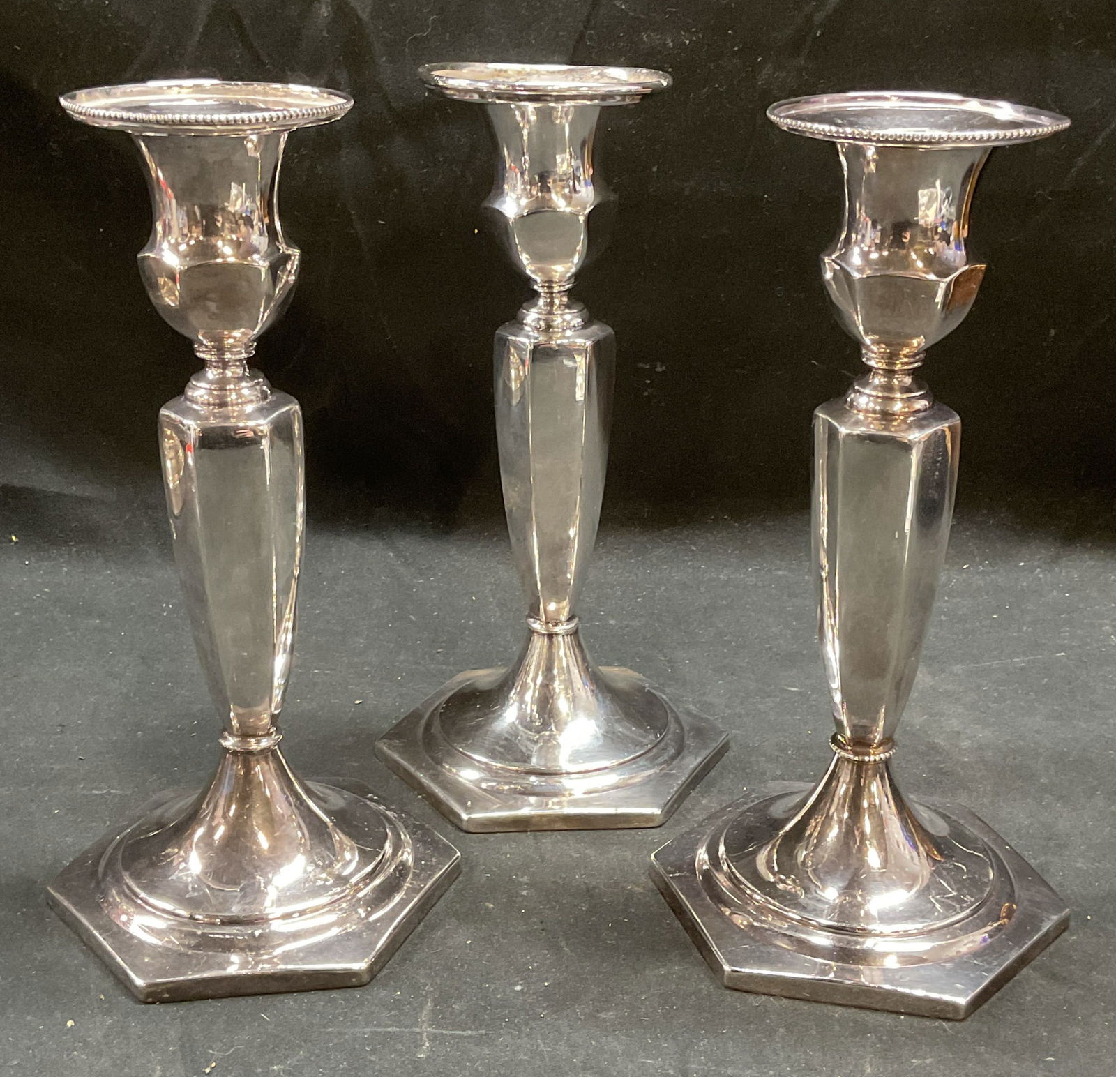 Lot 3 Antq Superior Silver Co Plated Candlesticks: Pair of antique, possibly vintage, Superior Silver Co quadruple silver plated hollowware candlesticks. Backstamp on undersides. Pattern number 1208. One vintage Superior Silver Co silver plated candle