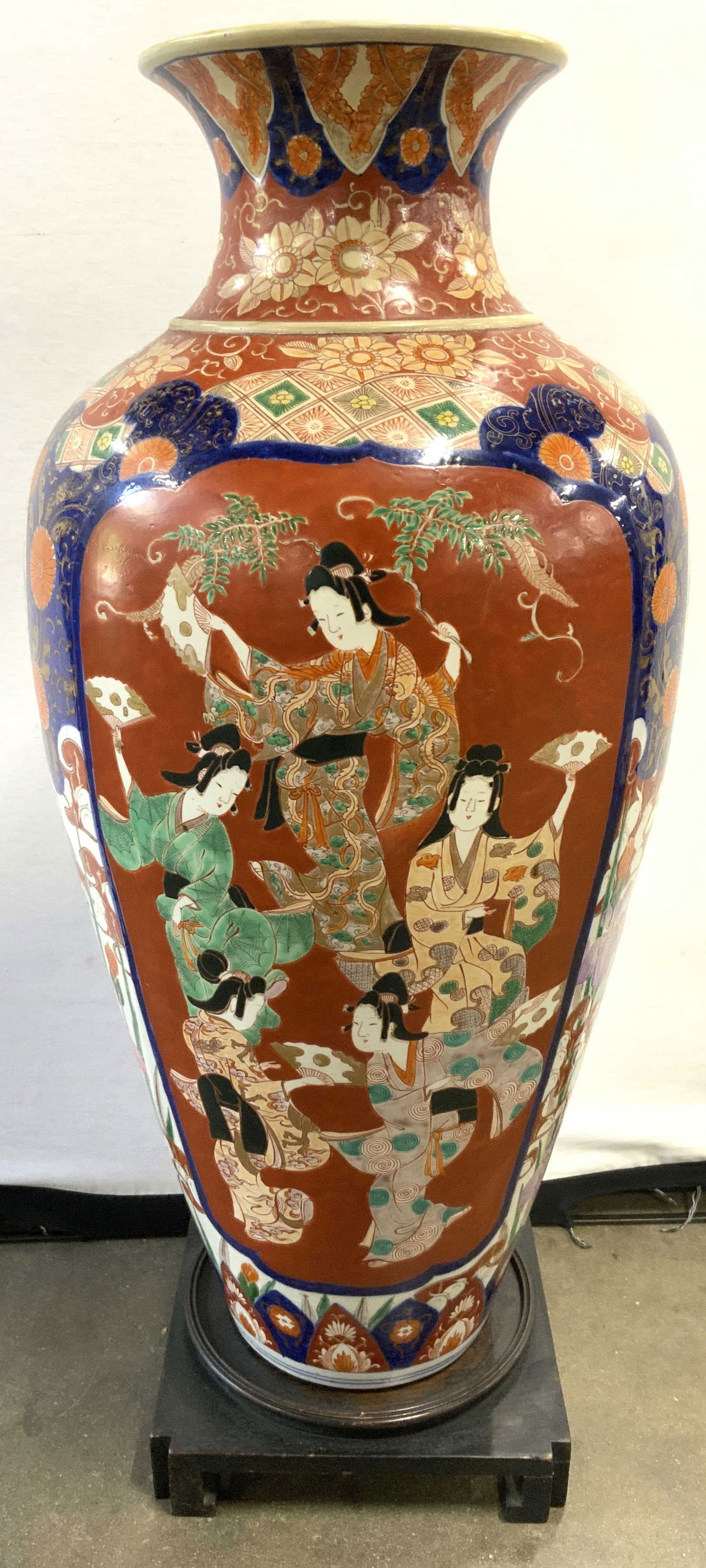 XL Vntg H Painted Asian Porc Vase W Wood Base 34in: Vase is vintage. Piece is hand painted with intricate multi toned floral, leaf & figural detail. Lot includes brown toned wooden base with Chow feet. Measures approximately 34 inches tall 14 inches wi