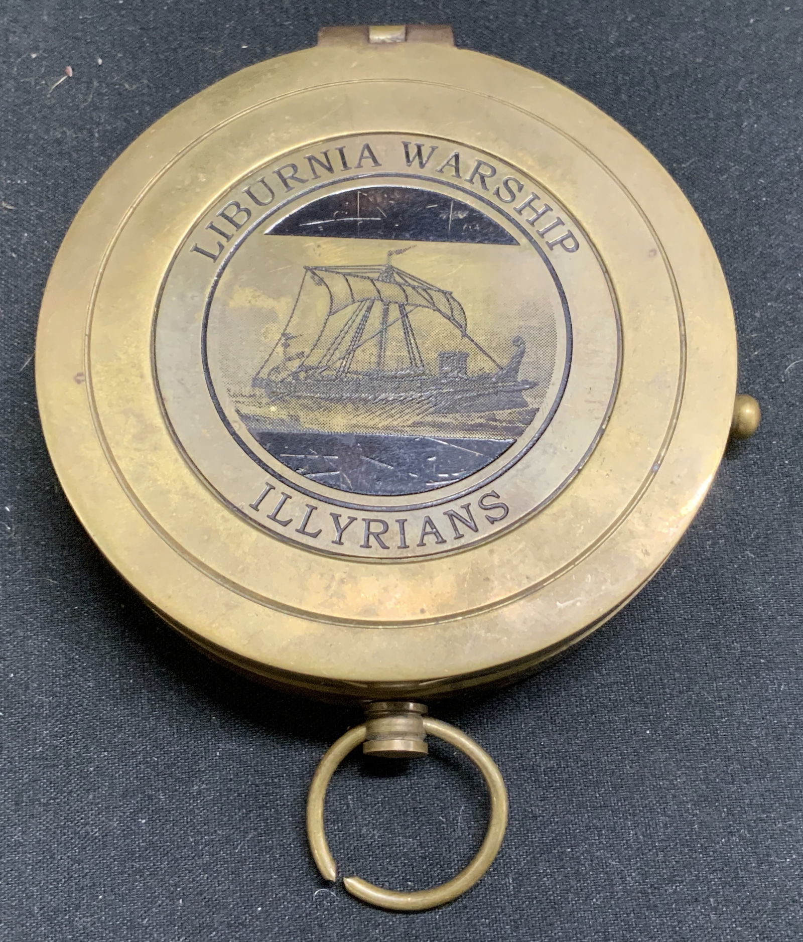 Vntg Liburnia Warship Illyrians Brass Compass: Compass is heavy brass material & featuring an engraving of a Liburnia Warship Illyrians on its lids, alongside with an illustration of the ship. Interior of compass reads, Liburnia warship, built by