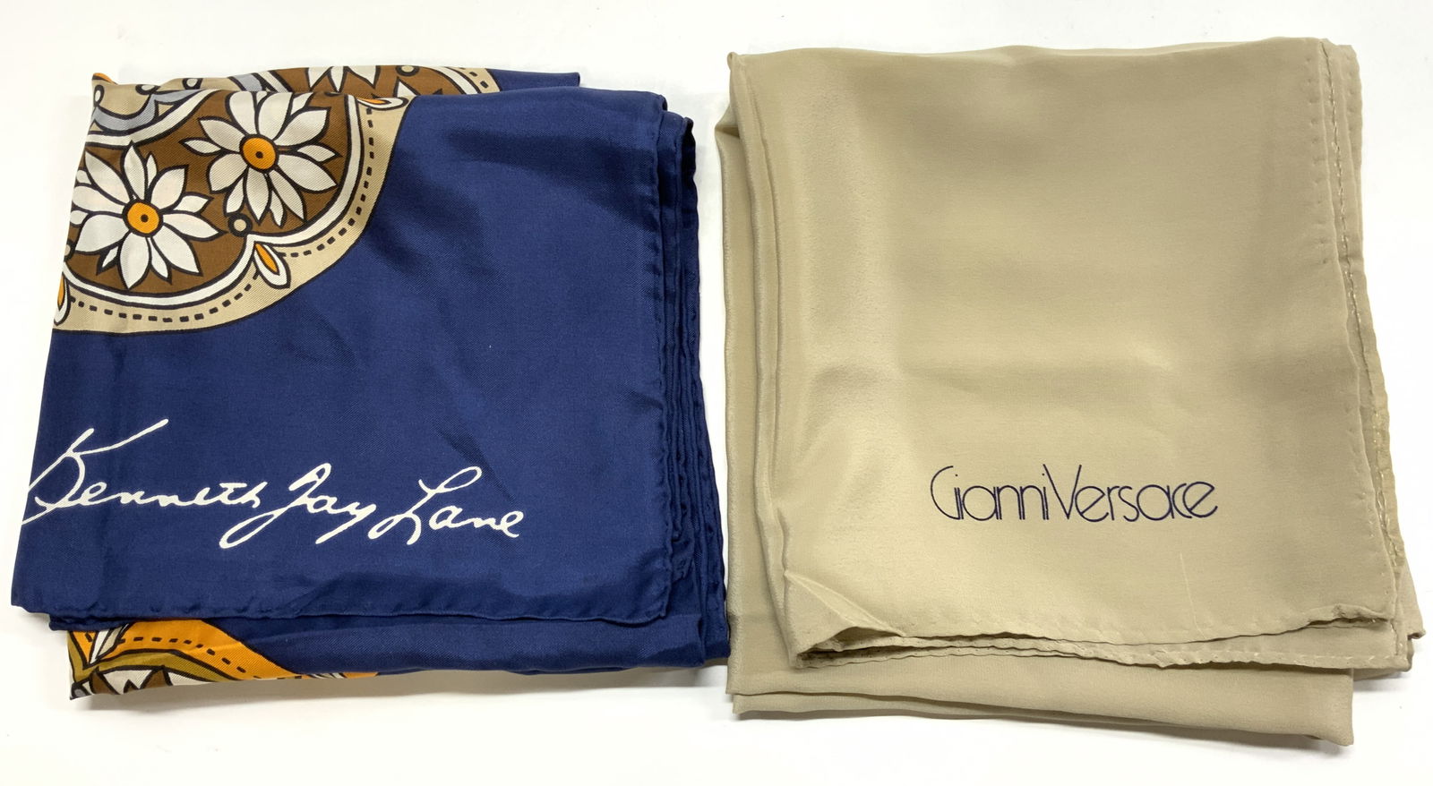 2 GIANNI VERSACE, KENNETH JAY LANE Silk Scarfs: 2 GIANNI VERSACE, KENNETH JAY LANE Silk Scarfs 2 silk scarfs. 1 silk scarf has a butterfly floral print & second scarf has a beige/tan color. Signed & marked. Surface wear consistent to age, use & exp