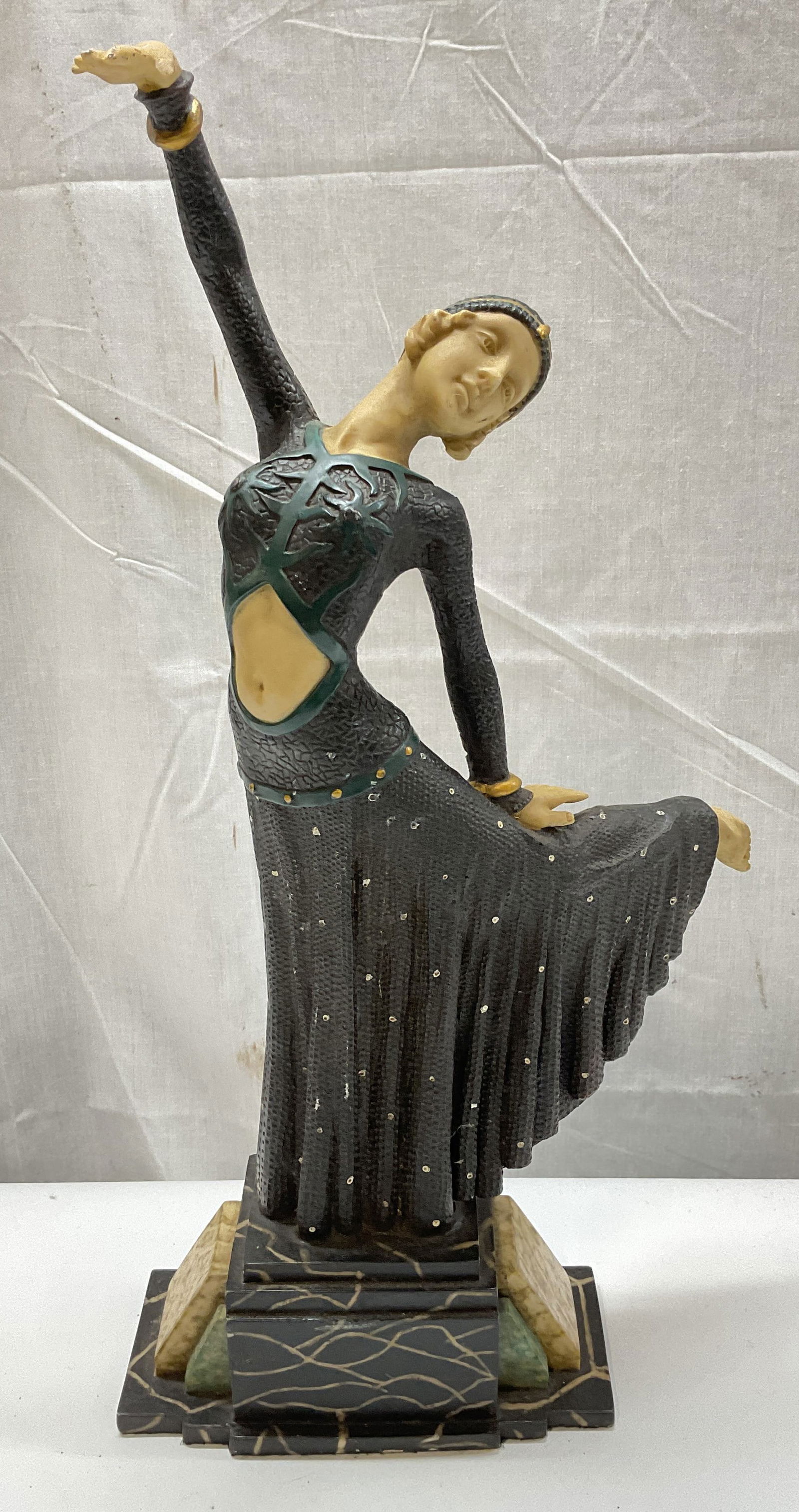 After CHIPARUS Art Deco Dancer Figural 18 In T: Art Deco style dancer figural. After DEMETRE CHIPARUS. Woman in costume. Hand painted with gilt decoration. Faux marble base. Cast resin. Piece has weight. Measures approx 8.5 x 5 x 18 inches. Surface