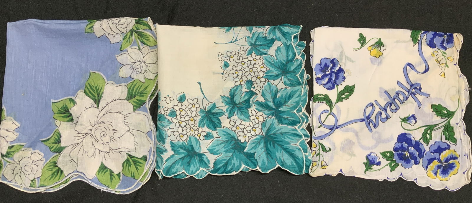Lot 3 Vntg Assorted Floral Linen Handkerchiefs: Handkerchiefs appears to be possible linen or cotton material. They feature floral patterns in shades of blue, white & yellow. Edges of handkerchiefs have scalloped edges. Surface wear consistent to a