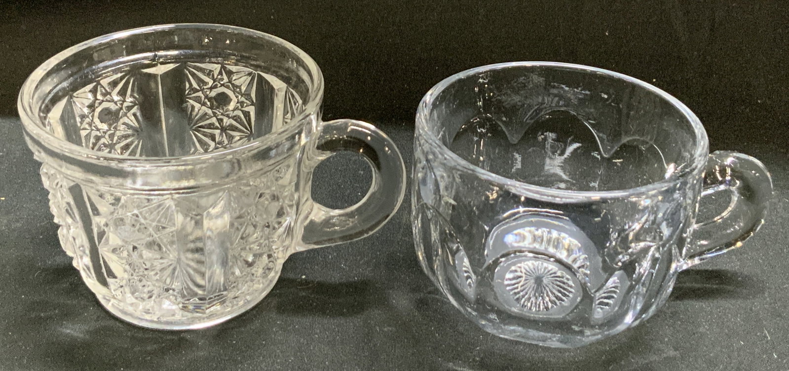 Lot 2 Vtg Glass Starburst & Radial Motif Punch Cups: Lot 2 Vtg Glass Starburst & Radial Motif Punch Cups Lot includes, 1 Vntg glass punch cup featuring starburst/star motifs & 1 clear glass punch cup featuring a radial pattern on the base. Surface wear 