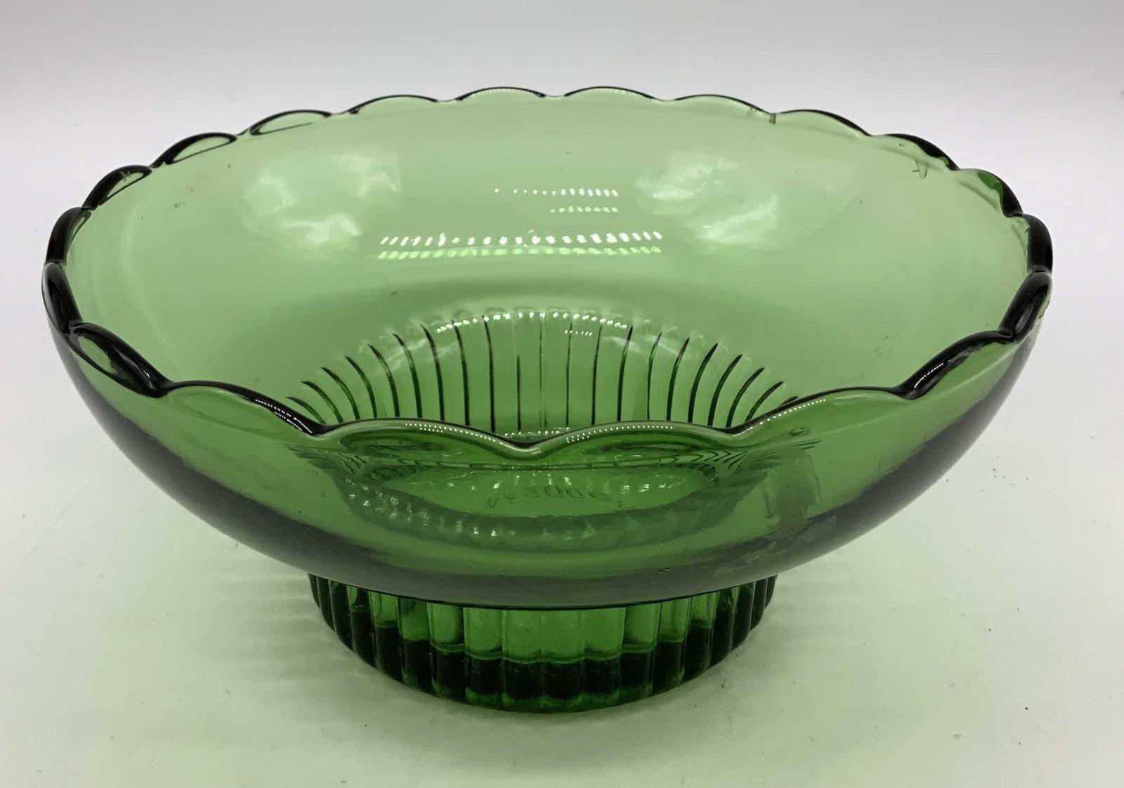 Vntg EO Brody Co Green Glass Pedestal Bowl USA: Vntg E.O Brody Co. Green Clear Glass Pedestal Bowl Bowl has a green clear glass material, which features a scalloped rim & ribbed pedestal base. Surface wear consistent to age, use & exposure. Signed 