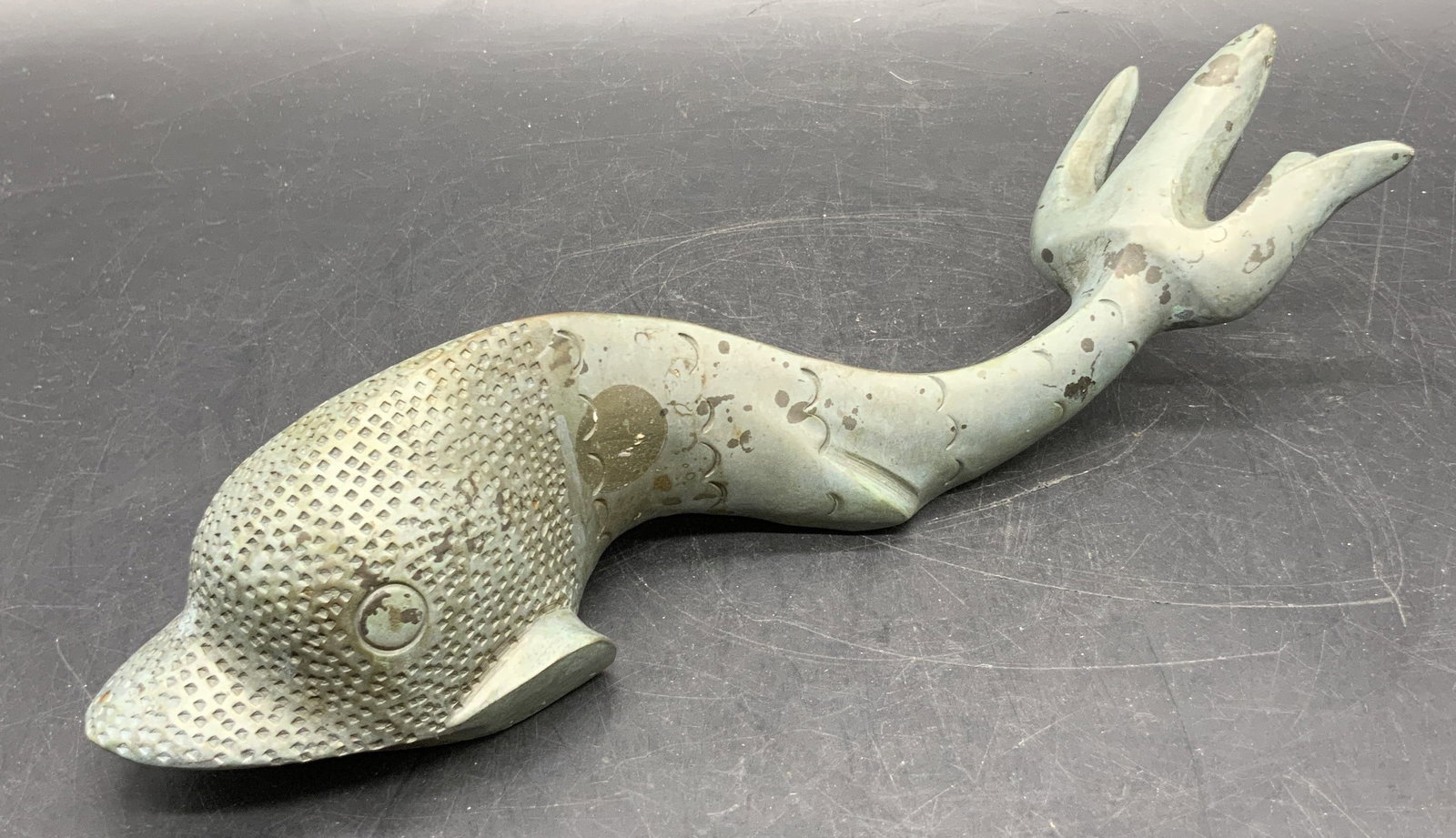 FF ABELA & SONS Metal Dolphin Figural, Malta: A handmade metal dolphin figural. Weighty piece. Underside signed HAND MADE, F.F. ABELA & SONS, MALTA. Measures approx. 2.5H x 10.25W in. Measured at widest point. Discoloration and surface wear prese