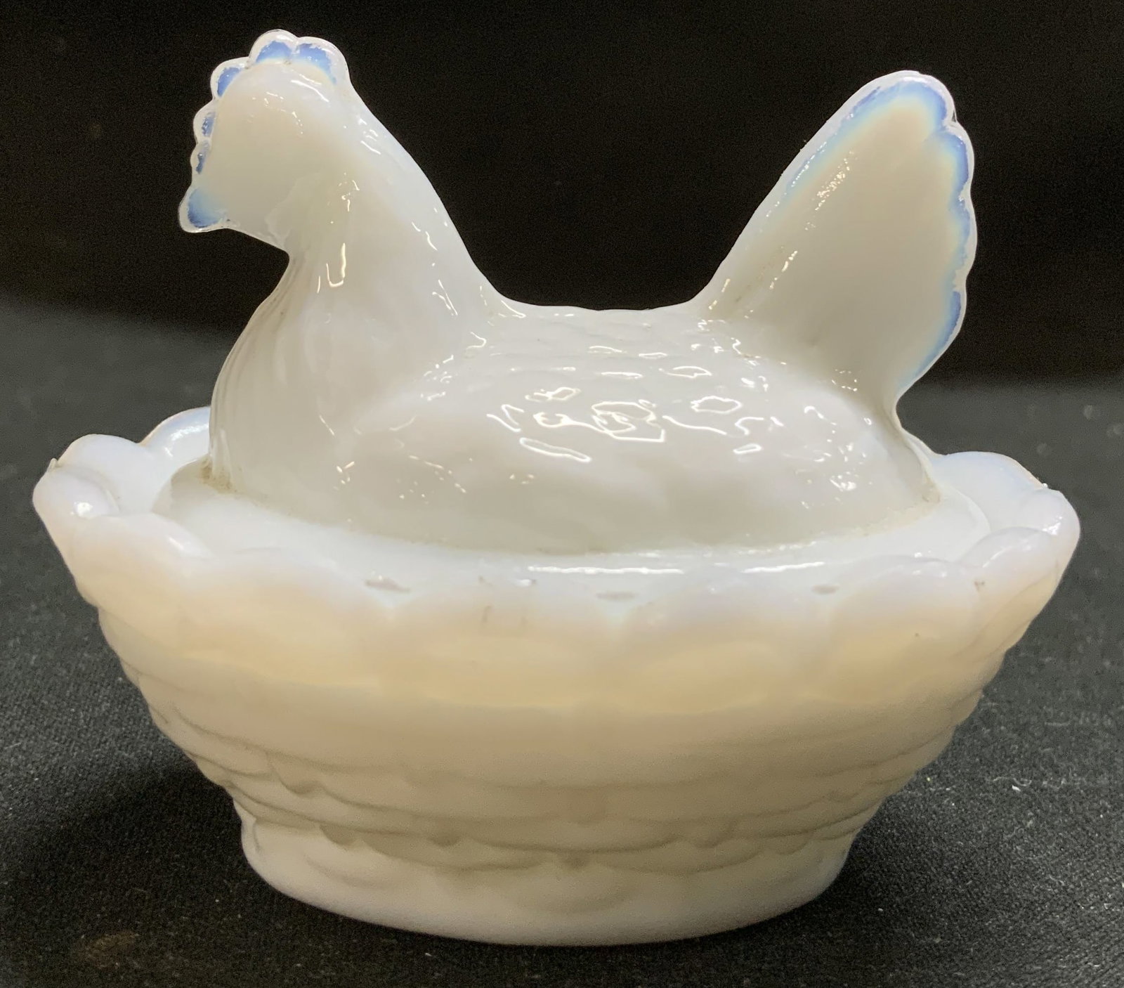 Westmoreland Milk Glass Hen Trinket Dish: Trinket dish in the shape of a milk glass hen. Hen features a bluish glow on the edges of the hens comb & tail. Signed & marked in interior of trinket dish. Surface wear consistent to age, use & expos