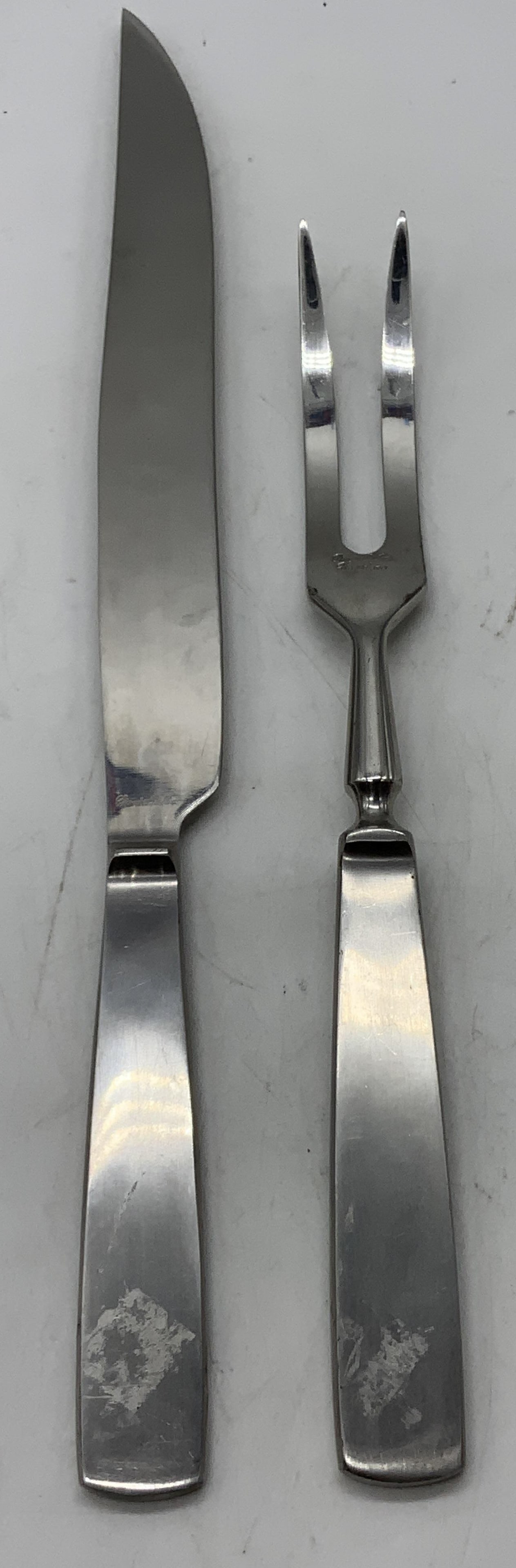 Stainless Knife & Fork Carving Set CAPRI ITALY: Carving set comes with a knife & two pronged fork. Pieces are stainless steel & feature a distinctive thick handle. Signed & marked. Reads, Stainless Pat Pend. CAPRI ITALY. Surface wear consistent to 