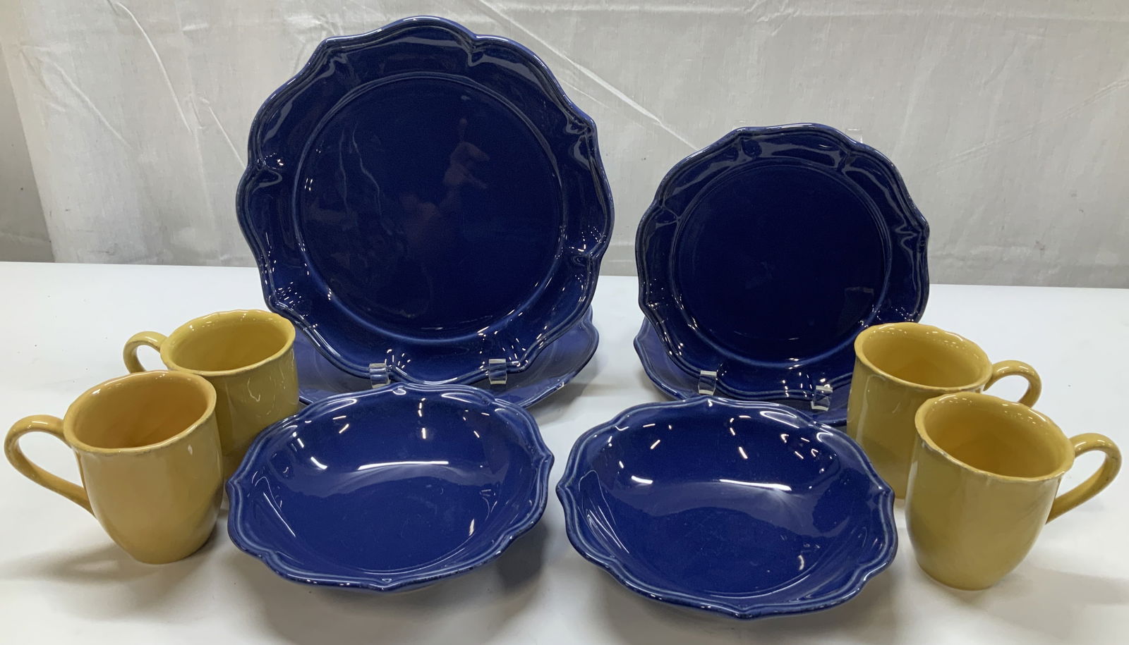 Lot 10 Pierre Deux Plates, Cups & Bowls PORTUGAL: Lot includes, 4 yellow cups, 2 bowls, 2 salad plates & 2 dinner plates. Plates & cups feature scalloped edges. Pieces have a glossy finish. Signed & marked on underside. Reads, PIERRE DEUX. FRENCH COU