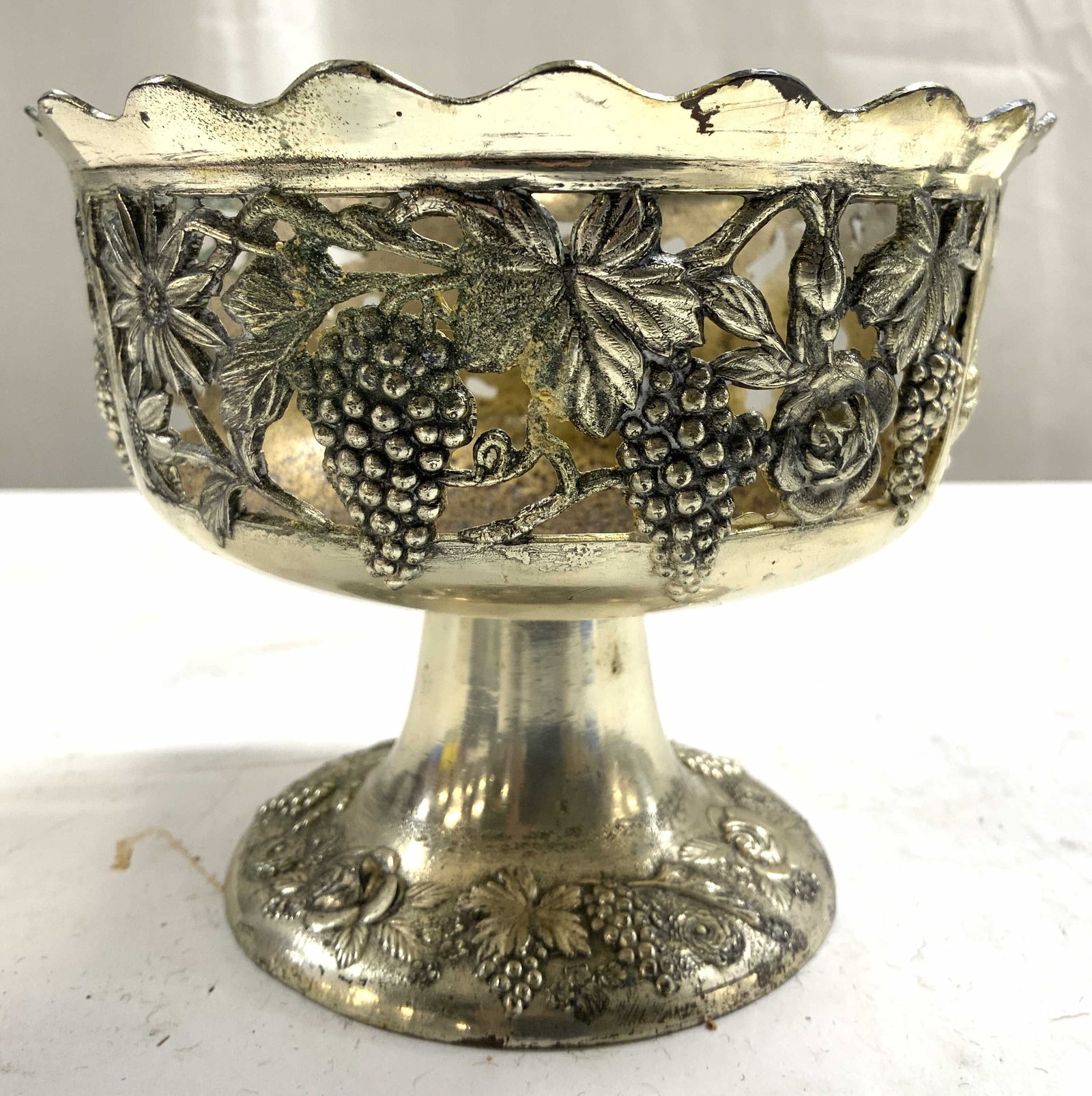 Silv Pl Repousse Style Pedestaled Dish JAPAN: Underside reads MADE IN JAPAN. Dish is pedestaled. Piece appears to be silver plated, possibly silver over copper. Dish has repousse style detail. Piece has floral, grape, & leaf detail in addition to