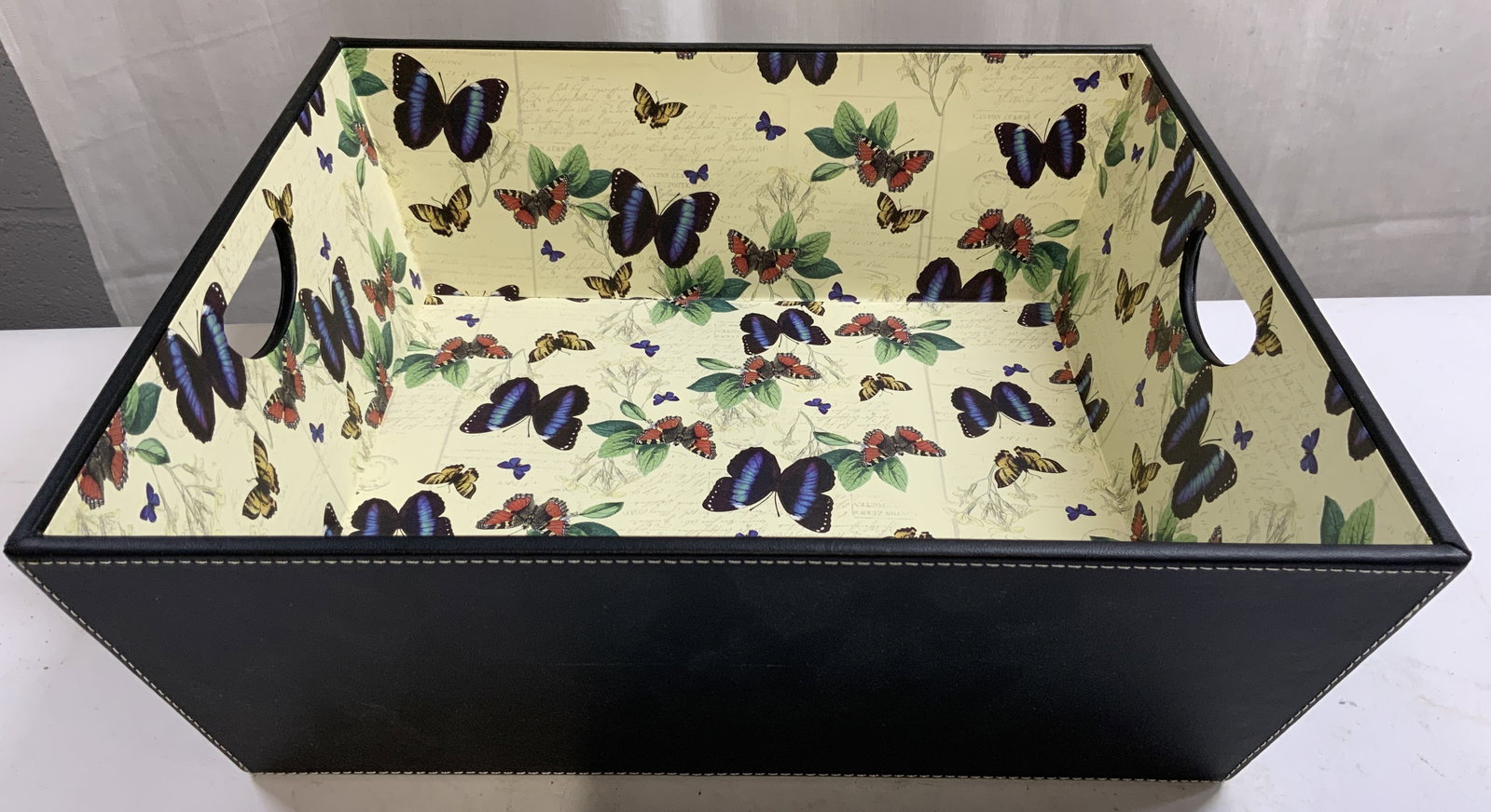 SICURA ITALIAN DESIGNS Butterfly Storage Tray: Underside is inscribed SICURA ITALIAN DESIGNS. Tray has black toned leatherette exterior. Interior has multi toned butterfly detail. Sides of piece have pierced handles. Tray measures approximately 15