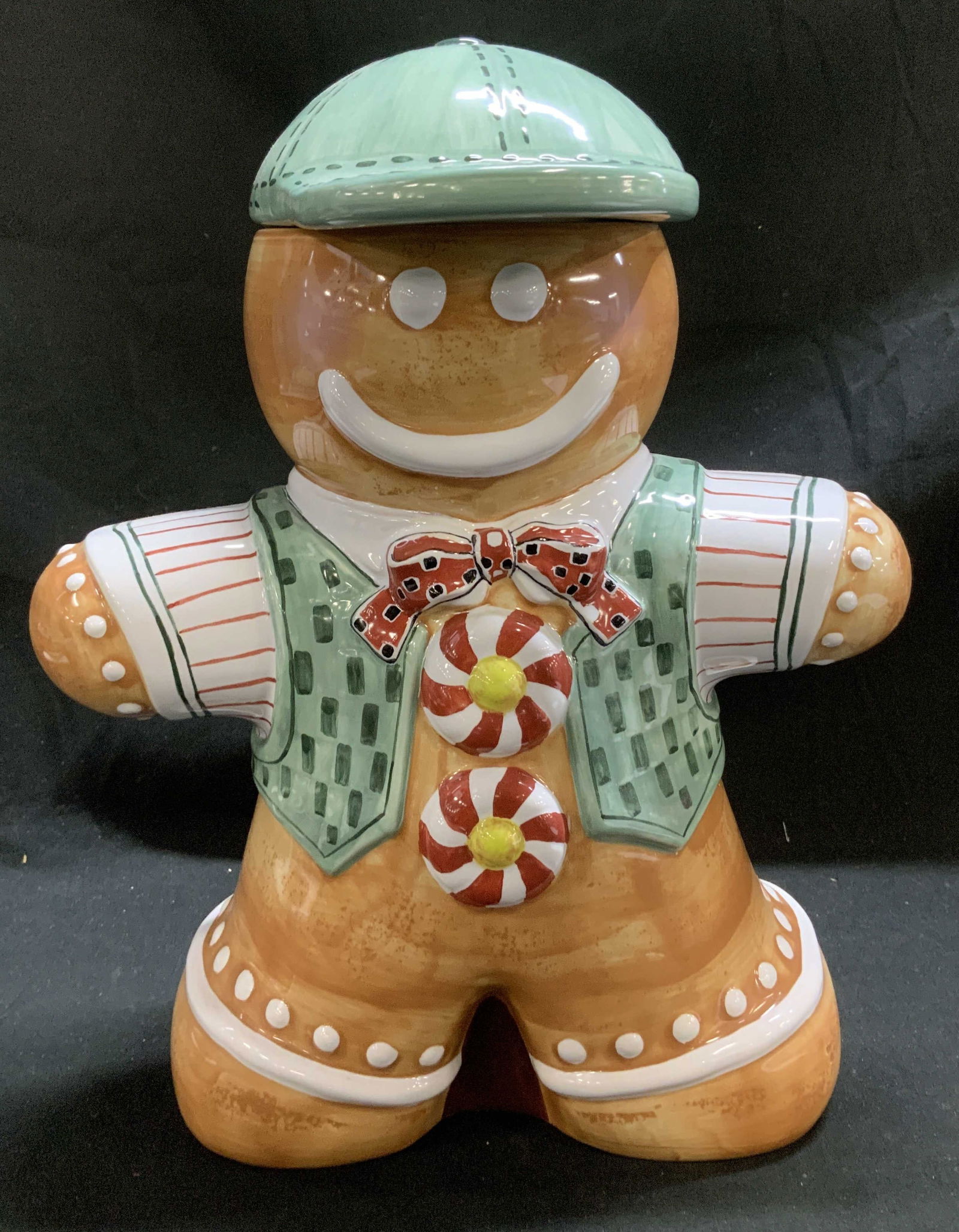 Too Good Gourmet Gingerbread Cookie Jar: Cookie jar is ceramic material & depicts a gingerbread man wearing a green vest with a red and white striped shirt & a matching bow tie. Cookie jar is hand-painted. Signed & marked on underside. Reads