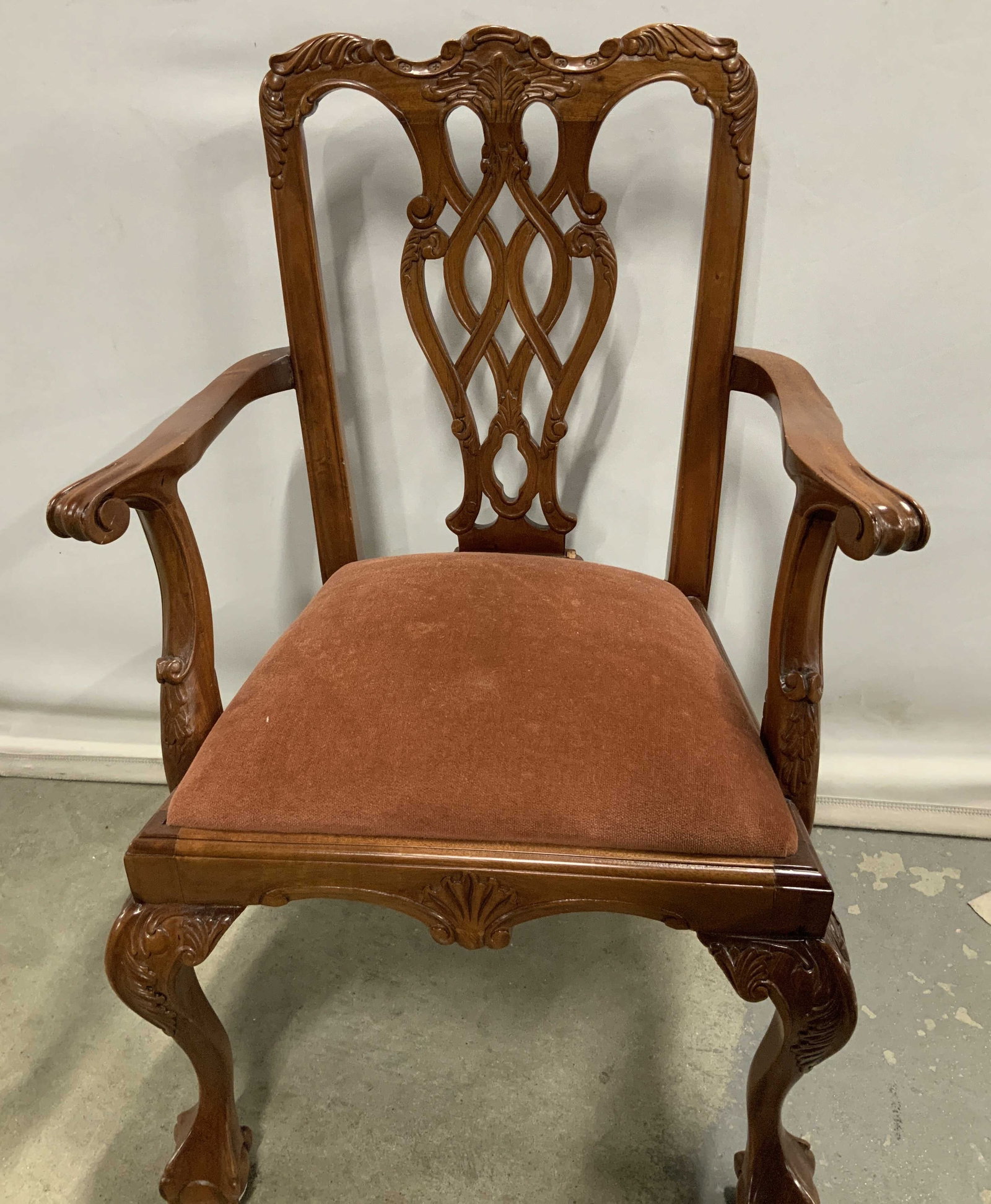 Vntg Carved Wood Armchair W Velvet Upholstery 26in: Vntg Carved Wood Armchair W Velvet Upholstery Armchair features an intricately carved wooden frame with an interlaced back, scrolled arms, cabriole legs & possible velvet material upholstered seat. Su