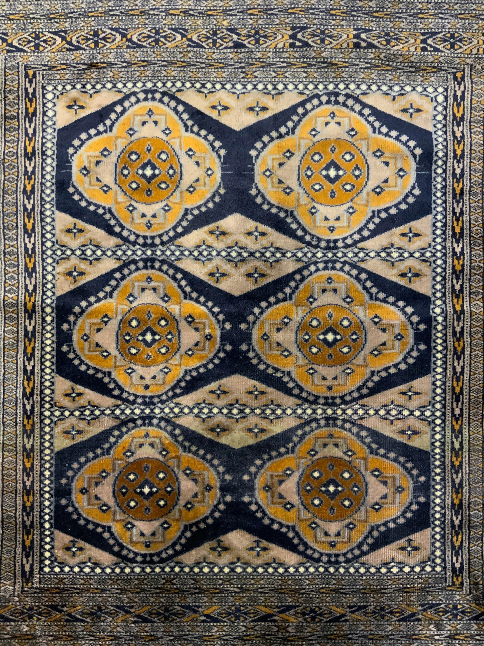 Vntg Hand Knotted Caucasian Shivran Rug: Appears to be signed on one side. Rug is hand knotted and wool. Piece is vintage. Rug appears to be Caucasian Shivran. Piece has intricate multi toned geometric detail. Edges of rug have cream toned f