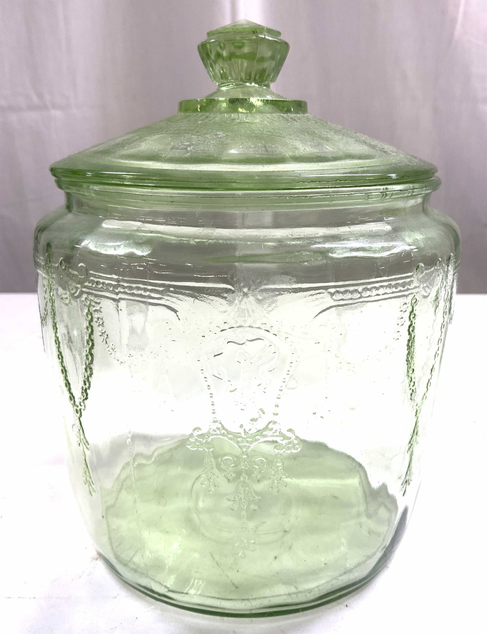Vintage Depression Glass Jar W Lid Green: Jar is vintage. Piece is green toned and glass. Jar includes lid. Depression glass jar with floral relief detail. Jar measures approximately 7 inches tall 5.5 inches wide. Jar, depression glass, green