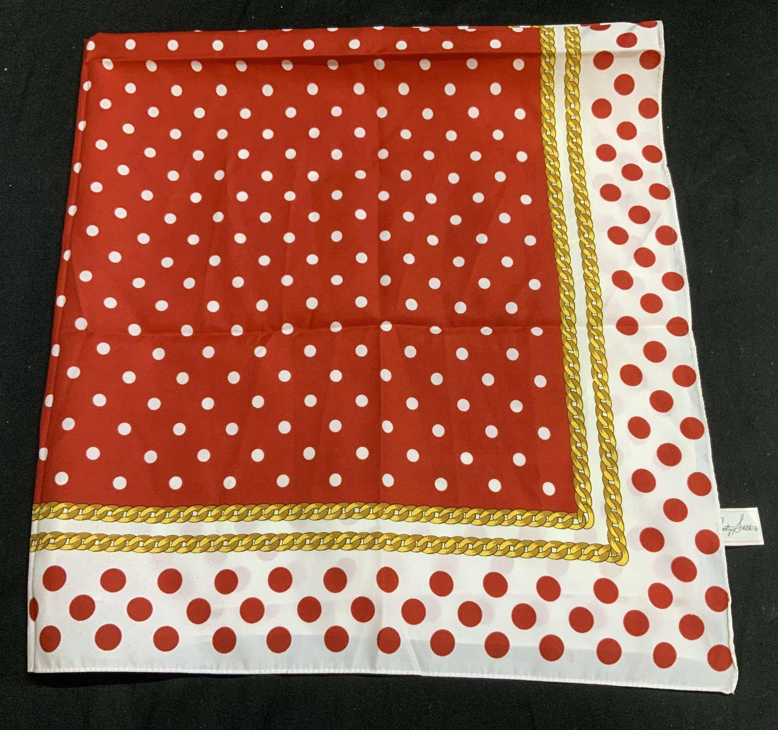 Jaclyn Smith Red Polka Dot & Chain Scarf ITALY: The scarf is white with a red polka-dot & gold-toned chain pattern. Scarf is polyester. Signed & marked. Reads, Jaclyn Smith. 100% Polyester. MADE IN ITALY. Surface wear consistent to age, use & expos