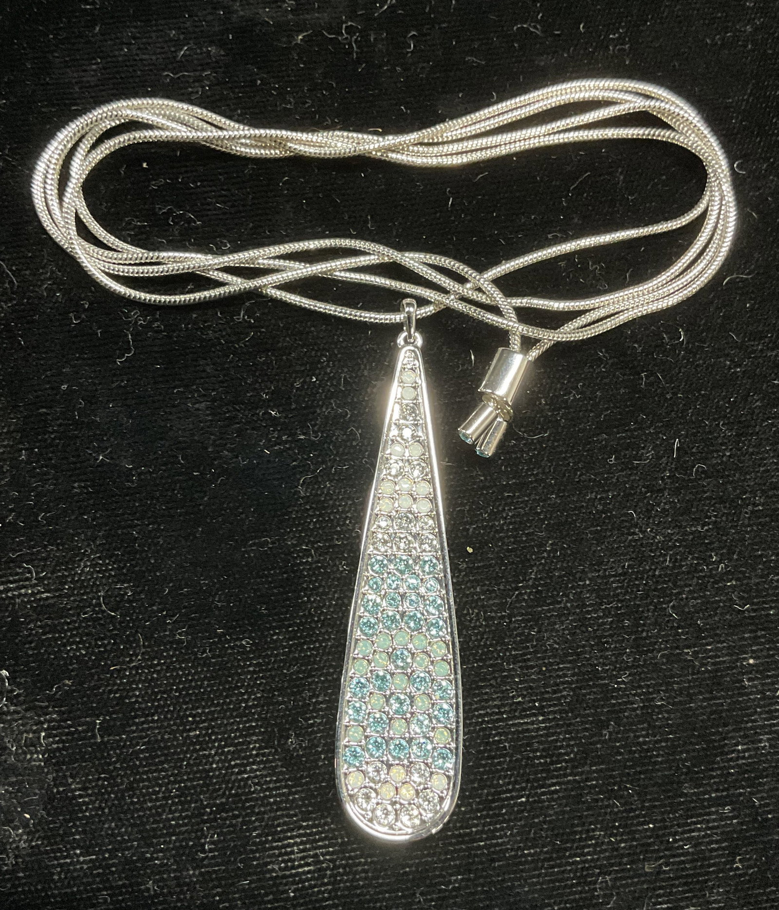 Swarovski Touchstone Crystal Pendant Necklace NIB: Touchstone by Swarovski silver tone drop pendant necklace with white, blue, and colorless crystals. Signed. New in box. Drop length approx 15.5 inches. Pendant approx 2.25 inches long. Some wear inclu