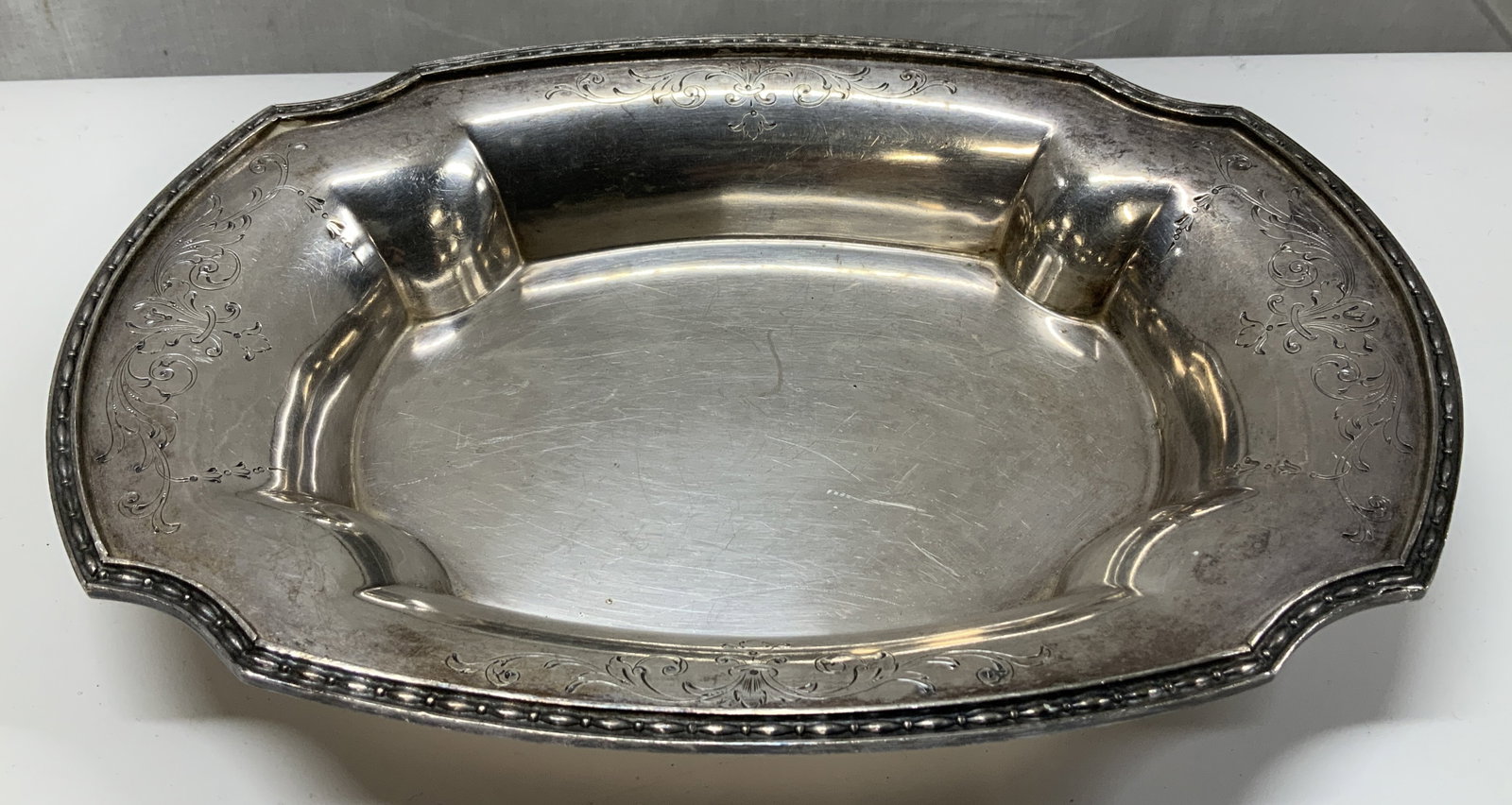 Pat.1914 Chippendale EPNS Floral Serving Dish: Serving dish is EPNS material & features a scalloped edge & engraved floral patterns. Patented date from 1914. Signed & marked on underside. Reads, CHIPPENDALE EPNS. PAT. 1914. 10in 28. Surface wear c