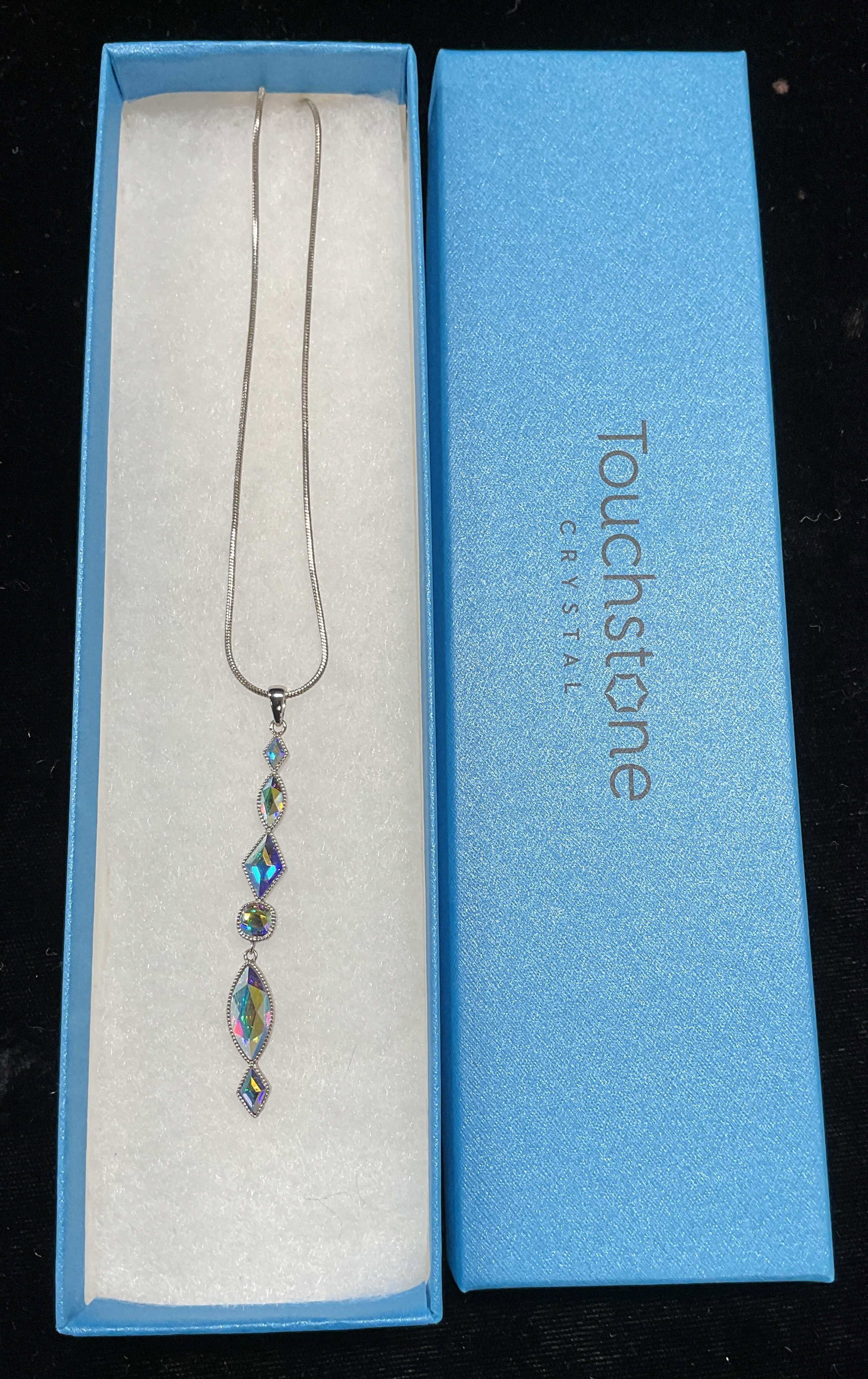 Swarovski Touchstone Crystal Pendant Necklace NIB: Touchstone by Swarovski silver tone pendant necklace. Iridescent crystal pendant. Signed. New in box. Drop length approx 9.75 inches. Pendant approx 2.5 inches long. Some wear including scratching obs
