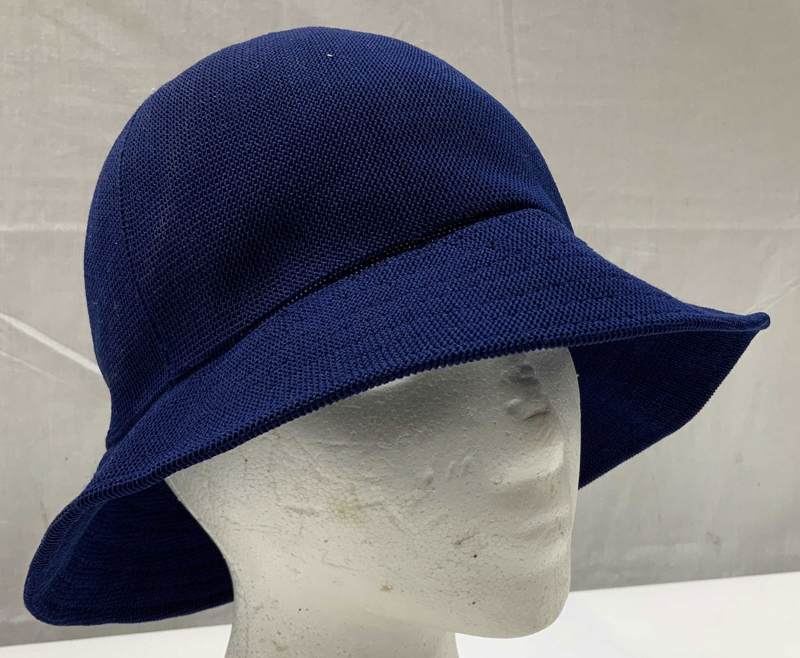 Kangol Design Blue Bucket Hat ENGLAND: Bucket hat features a dark blue color & appears to be possible cotton material. Signed & marked. Reads, KANGOL. MADE IN ENGLAND DESIGN. Surface wear consistent to age, use & exposure. Measurements: le