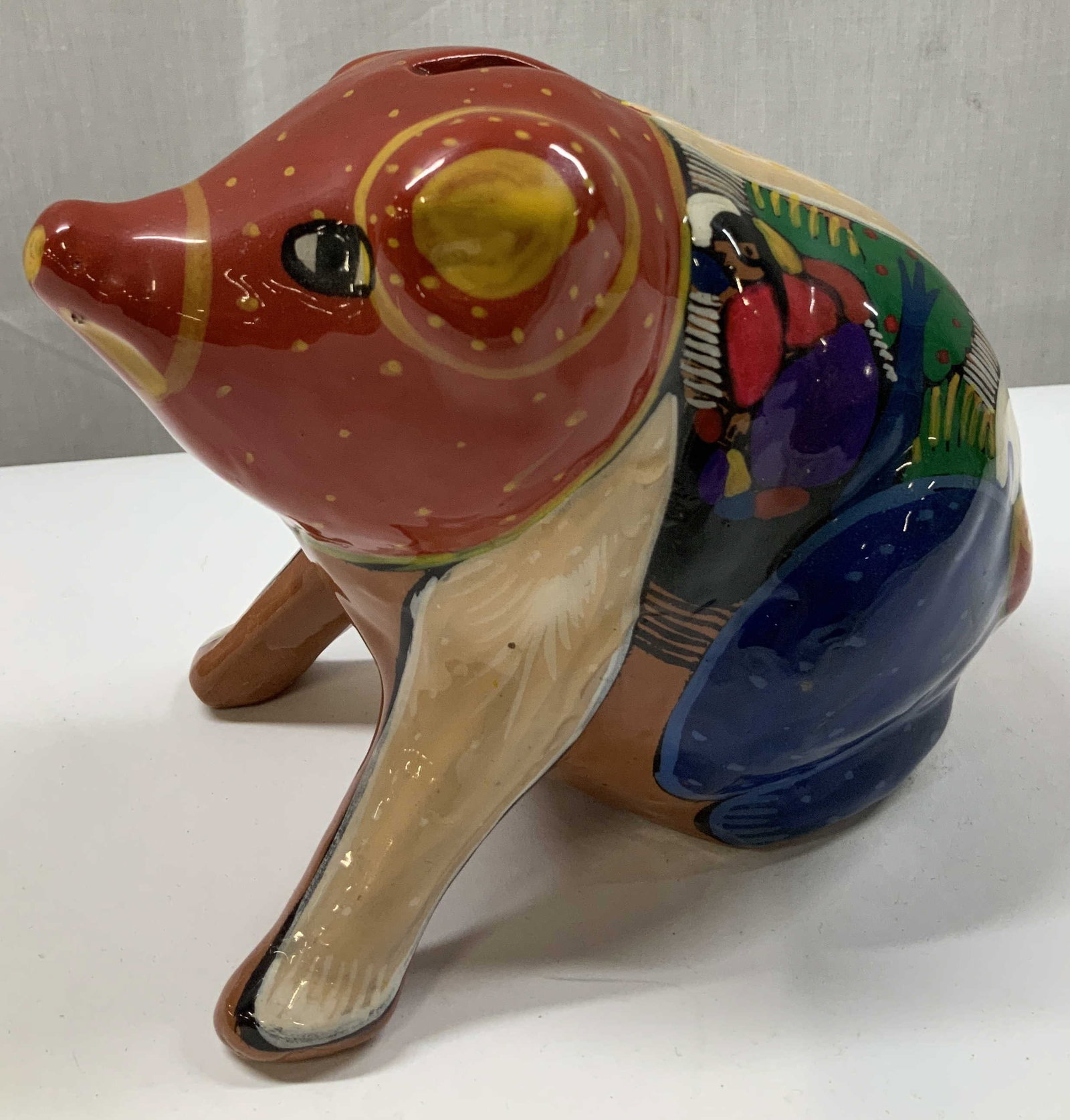 Hand Painted Talavera Style Terracotta Pig Bank: Coin bank is hand-painted & features a Mexican Talavera style. Coin bank is shaped like a pig with intricate details of figures & vibrant colors. Appears to be terracotta material. No visible signatur