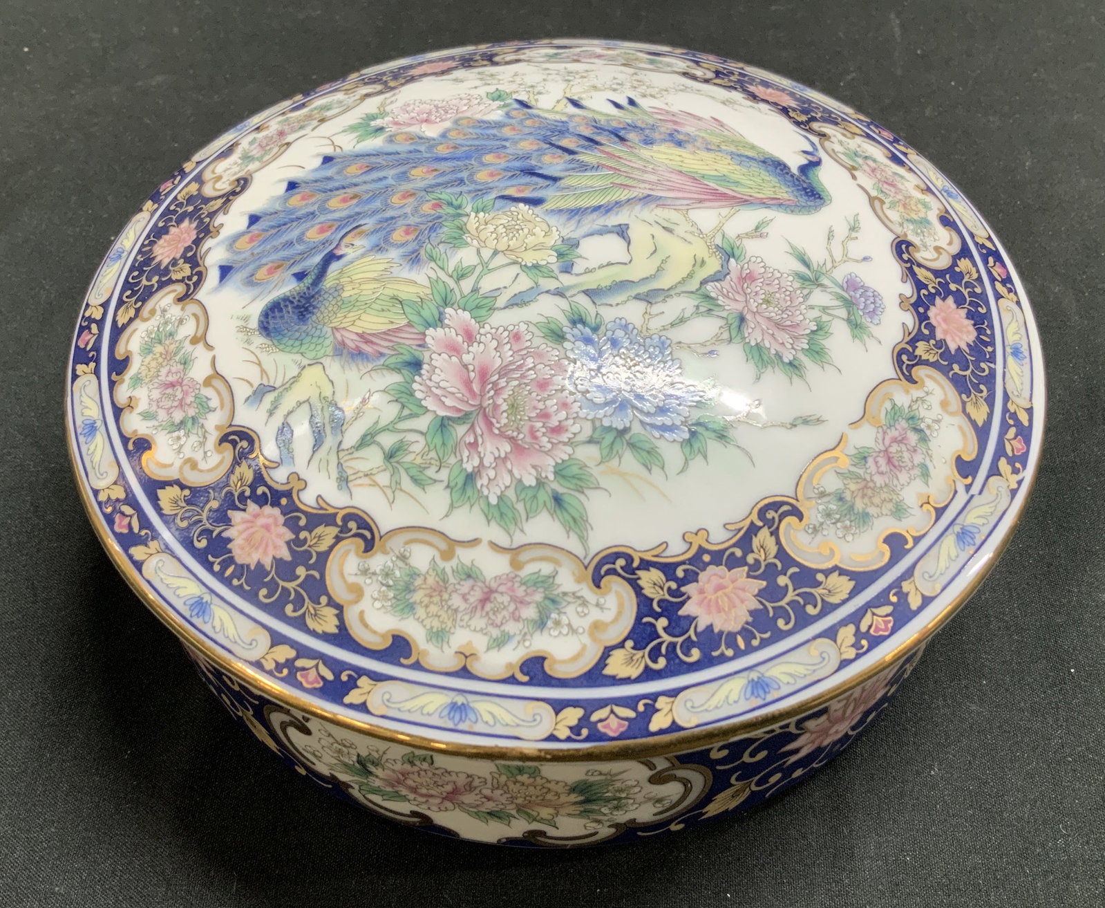 ASAHI Peacock Motif Porcelain Keepsake Box JAPAN: Keepsake/trinket box is porcelain material & features a peacock w floral design. Base of the box has a dark blue border with an ornate floral and scroll pattern, accented with gold details. Signed & m