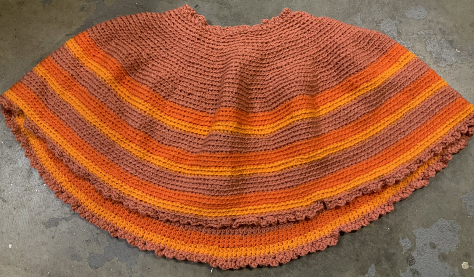Orange Toned Crocheted Christmas Tree Skirt: Christmas round tree skirt featuring a hand-crocheted orange toned pattern. Pattern has orange light & dark colors. Surface wear consistent to age, use & exposure. Measurements: length 27.2in x width 