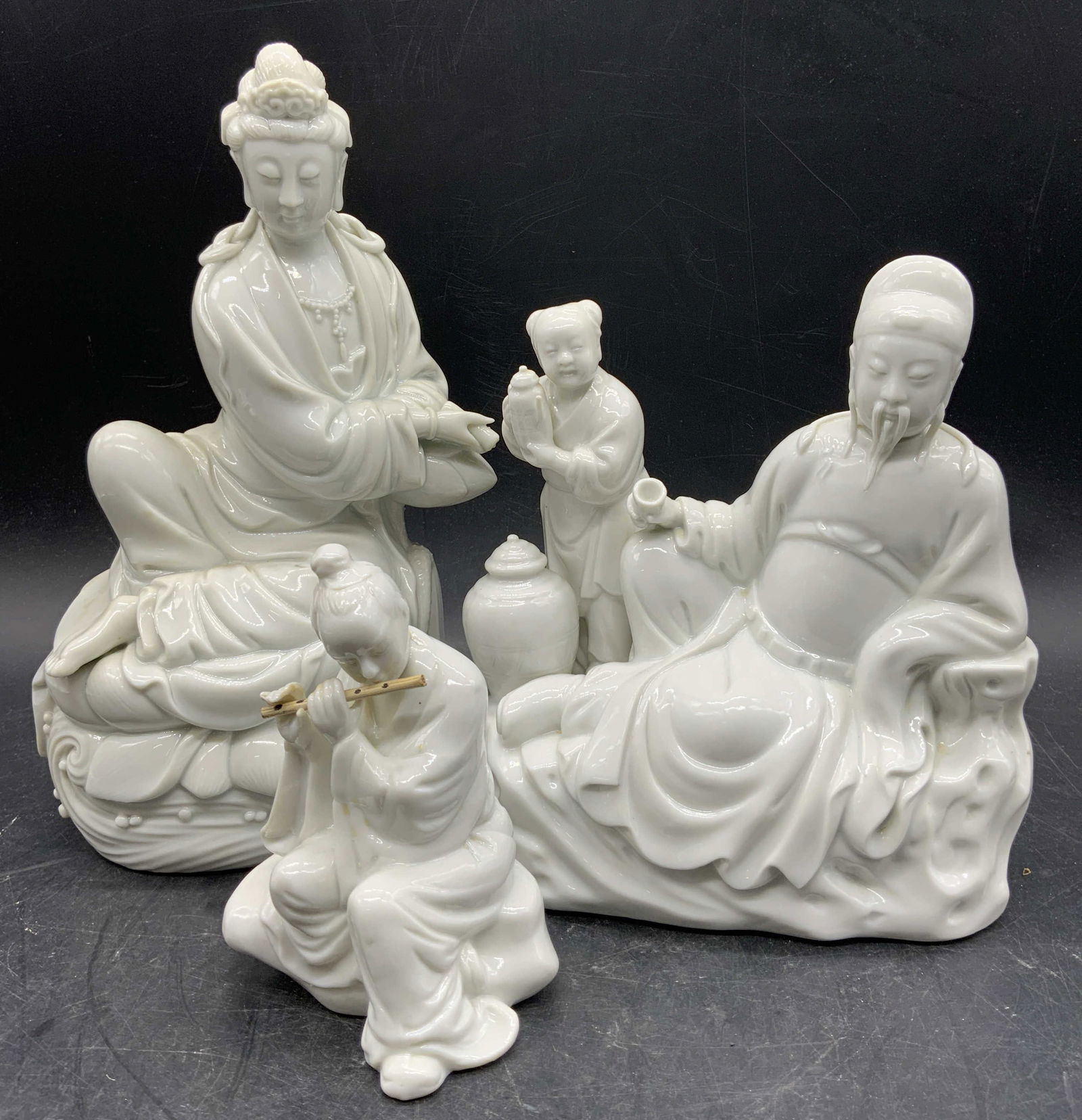 Lot 3 Atq Chinese Dehua Porc Blanc De Chine: Lot includes 3 porcelain figures. Each appear to be antique possibly vintage. Blanc de chine white toned porcelain figures. Includes seated female figure on flute, Guanyin figure, elderly male figure