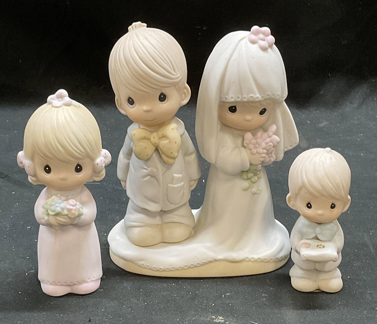 Lot 3 Precious Moments Porc Wedding Figurines: Lot of 3 Vintage Enesco Precious Moments porcelain wedding themed figurines. Bride and groom, bridesmaid, ring bearer. All signed. Largest approx 4 x 2.5 x 5 inches. Includes boxes. Some wear to all c