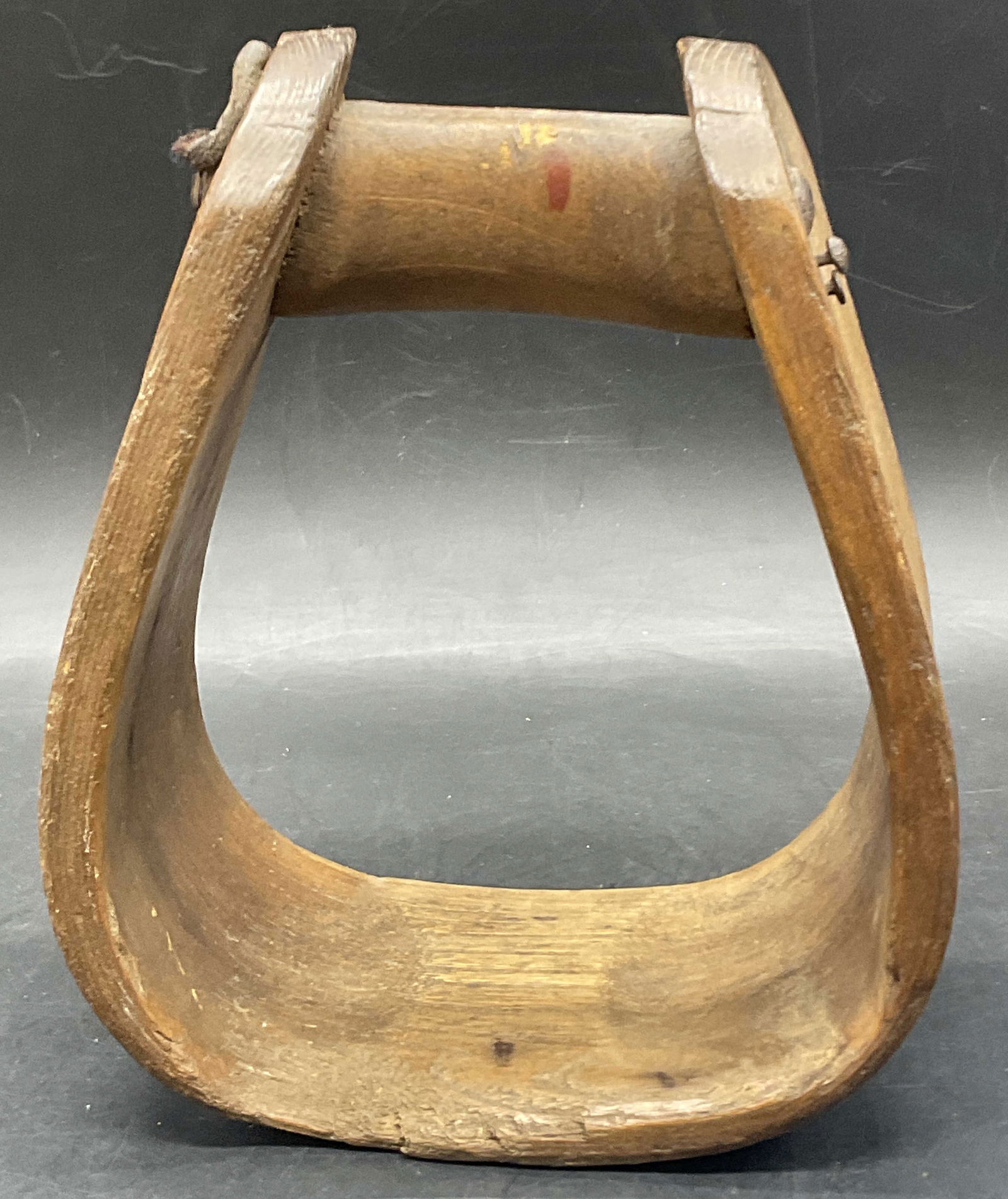 Vintage Wooden Horse Stirrup: Vintage Wooden Horse Stirrup. Crafted from wood, leather, and metal. Measures approx. 7H x 5.75W in. Chipping, discoloration, surface wear, cracking to wood, and holes to piece present. home decor, ho