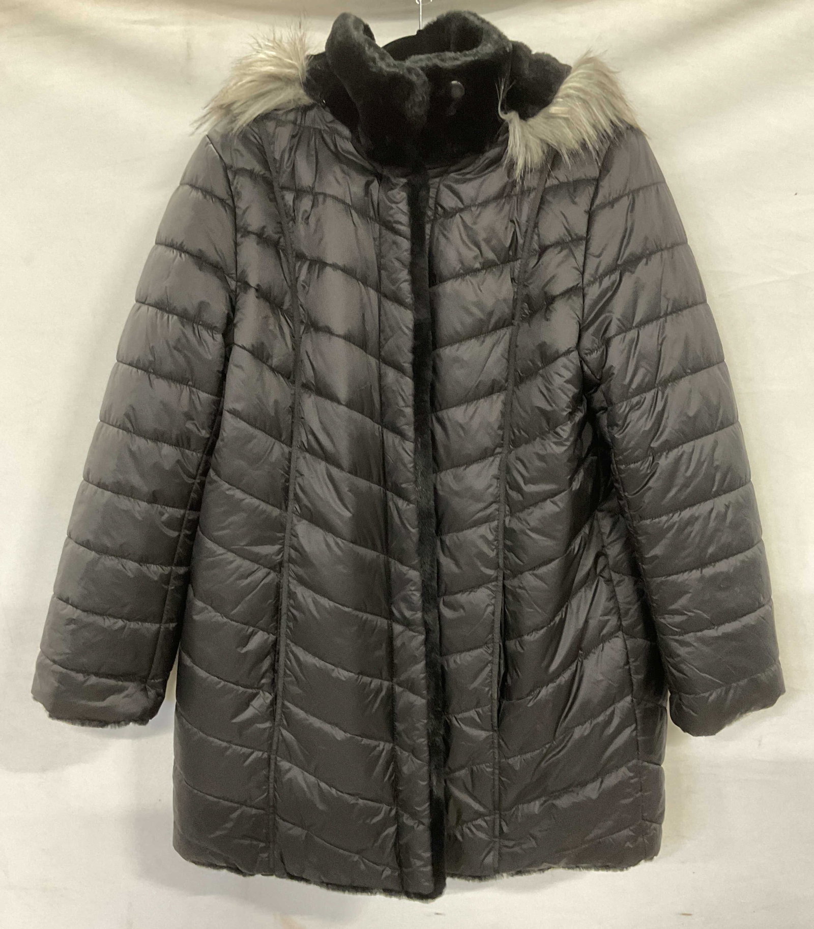 Dennis Basso Black Quilted Faux Fur Coat: Dennis Basso black quilted faux fur lined and trimmed coat with hood. All synthetic materials. Size medium. Some wear consistent with exposure. Dennis basso coat, designer coat, quilted coat, faux fur