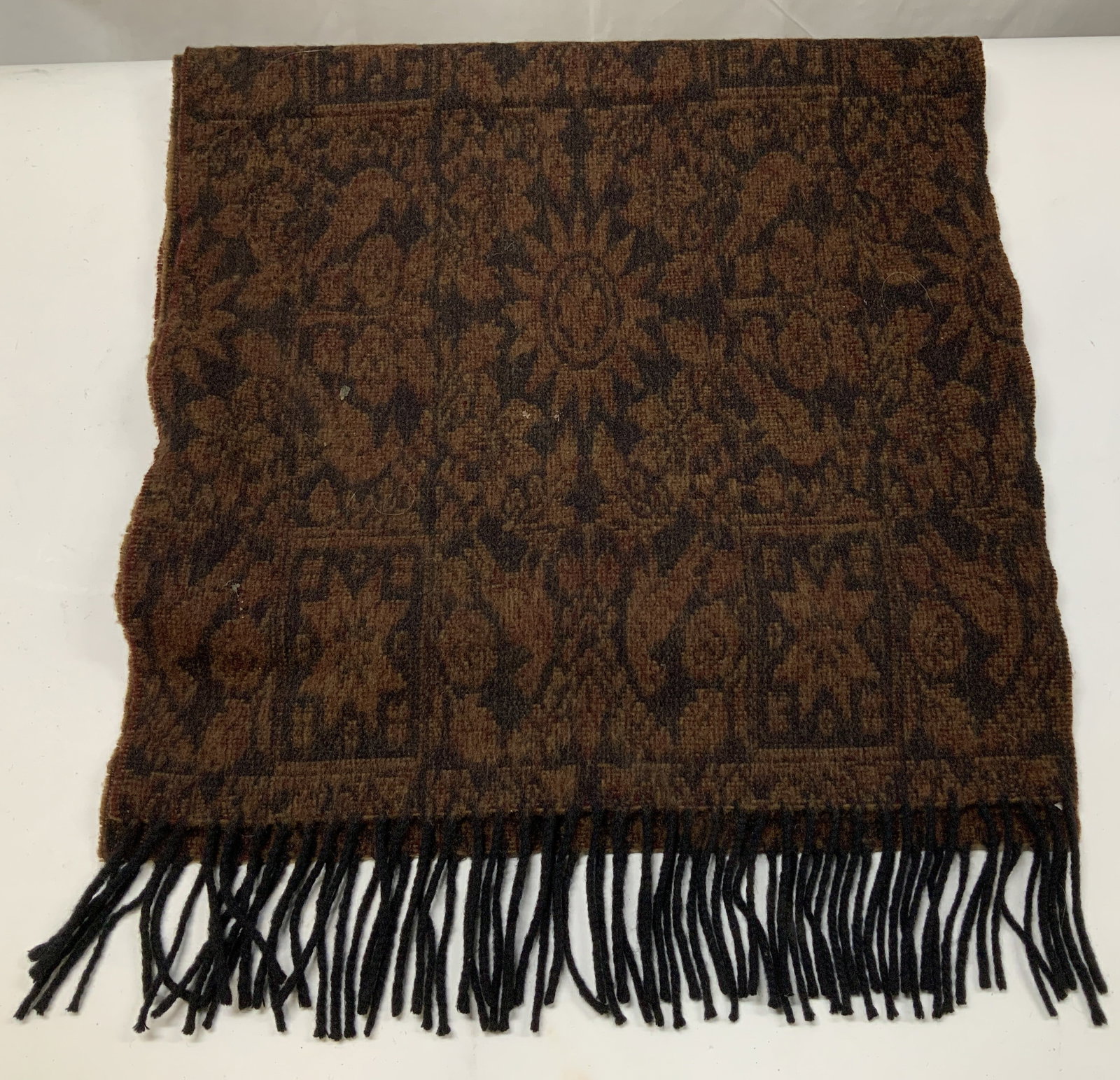 Vntg Claridge Star Motif Lambswool Scarf SCOTLAND: Scarf features star like motifs & sunburst shapes w brown & black tones. Ends of scarf has fringes. 100% lambswool. Signed & marked. Reads, CLARIDGE SUPER 100s 100% lambswool. Superfine merino. Made i